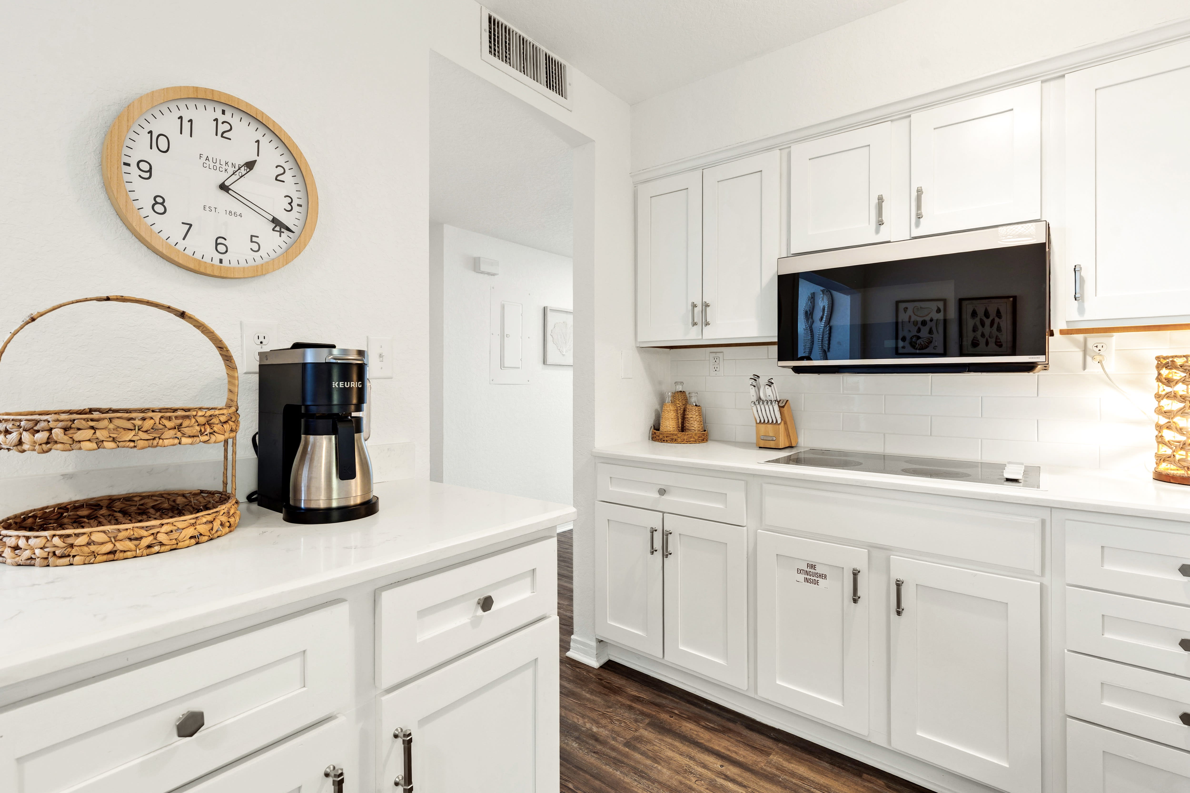Your pristine white kitchen awaits with modern appliances and charming touches—perfect for brewing morning coffee or preparing meals.