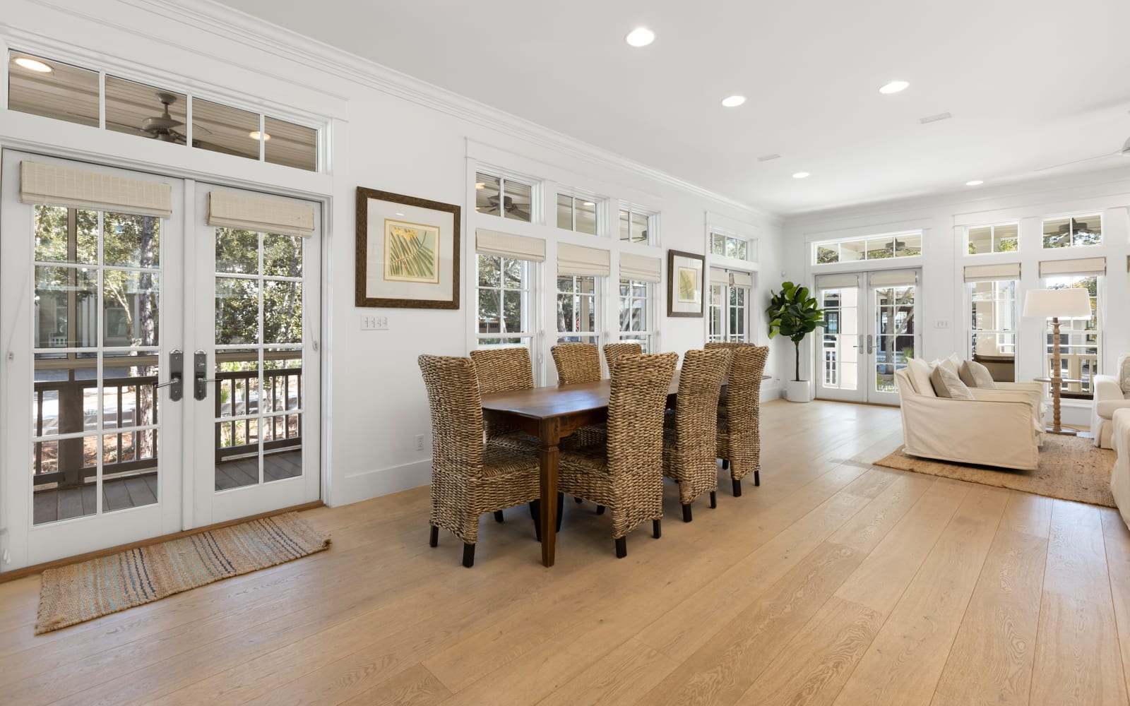 Gather around this stunning dining table where natural wicker chairs invite memorable meals together in bright, airy elegance.