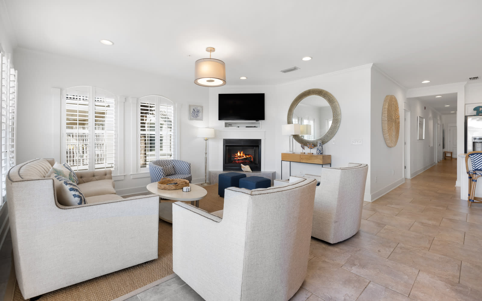 Sink into plush seating around the crackling fireplace while your favorite shows play on the mounted TV—pure comfort awaits.