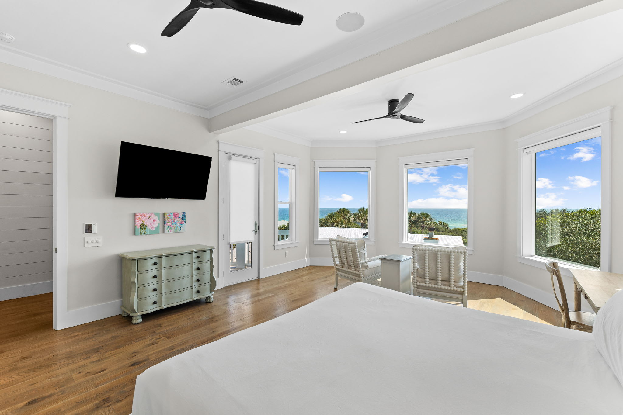 Gulf-view primary suite with private balcony and spa-inspired bathroom.