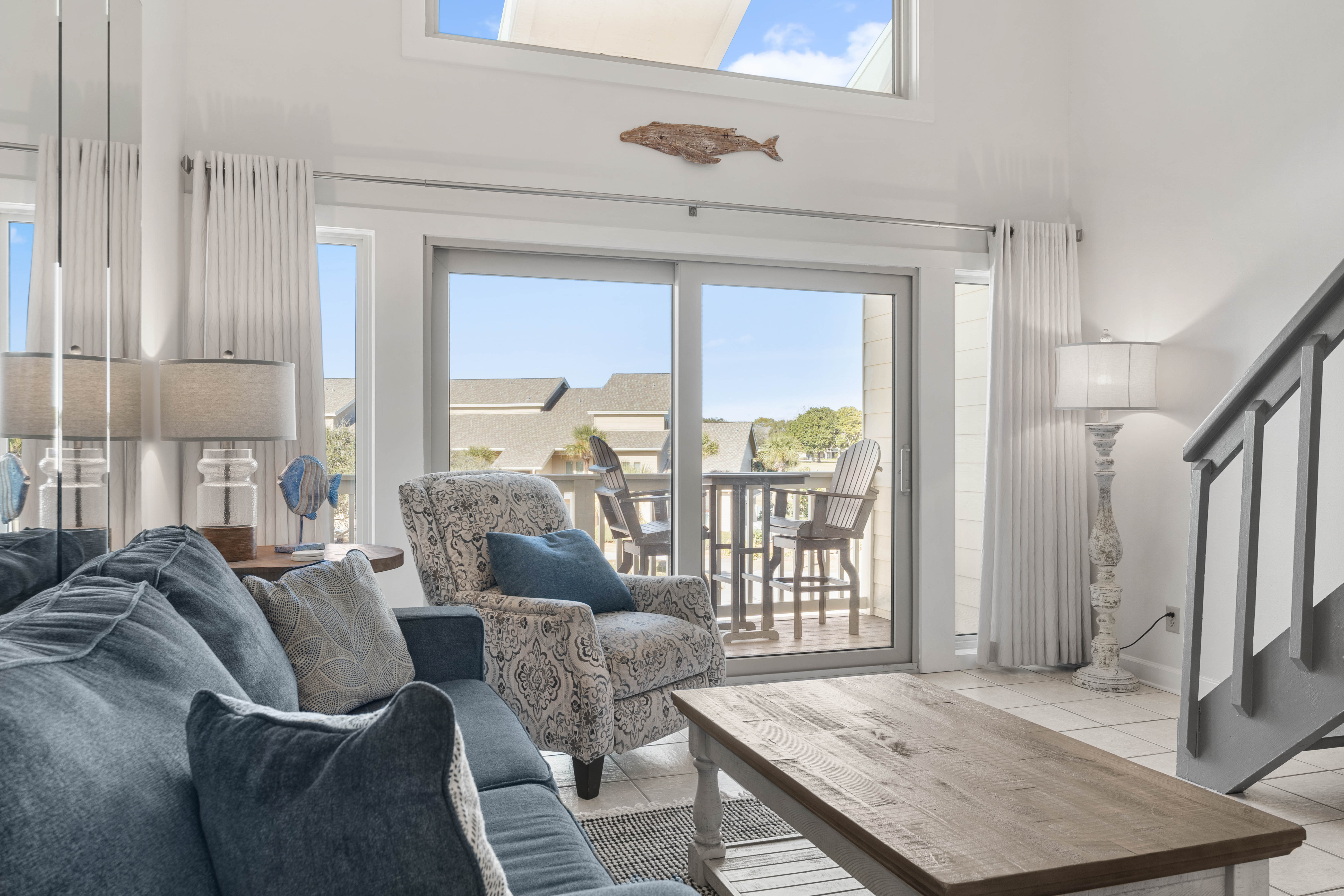 Unwind in your bright living space with cozy seating and direct balcony access to enjoy peaceful outdoor moments.