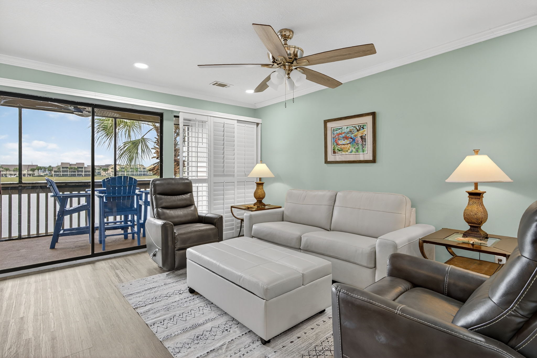 Unwind in your spacious living area with comfortable leather seating, tropical breezes from your private balcony, and soothing coastal views to enhance your relaxation.