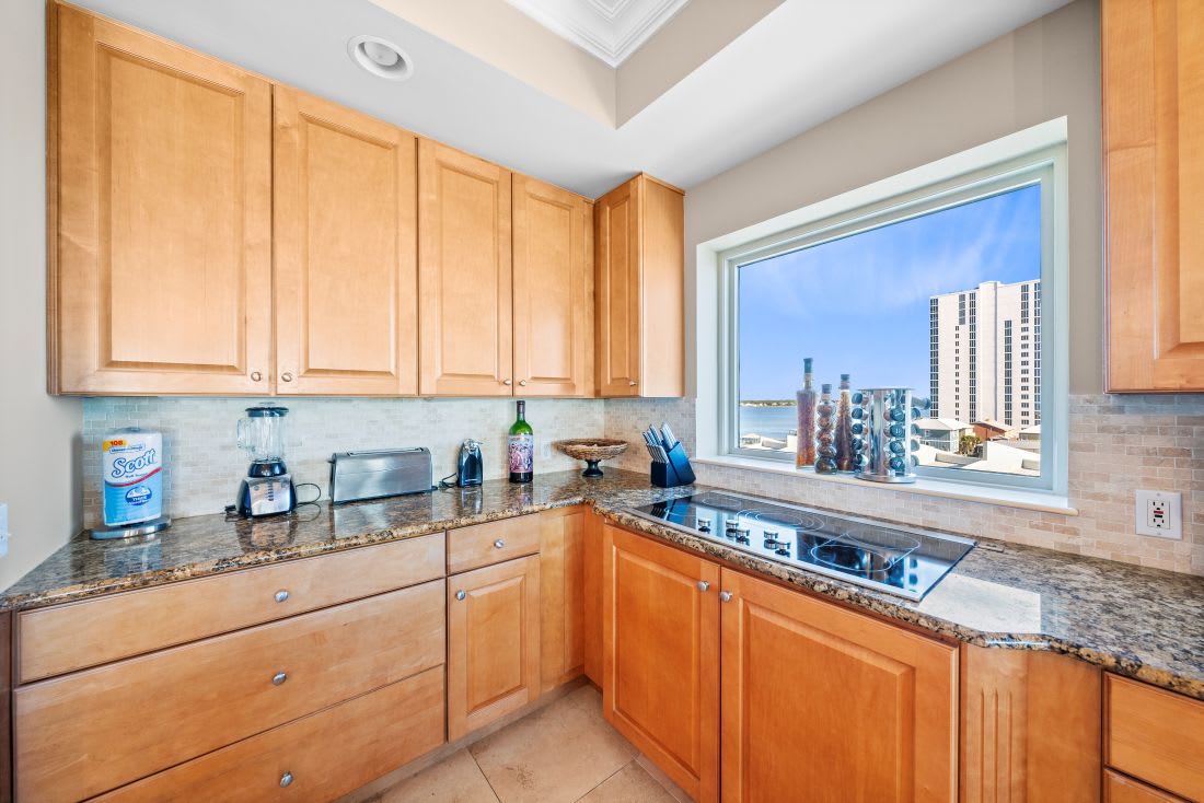Your fully equipped kitchen features granite counters and city views, perfect for preparing meals while enjoying the urban skyline.