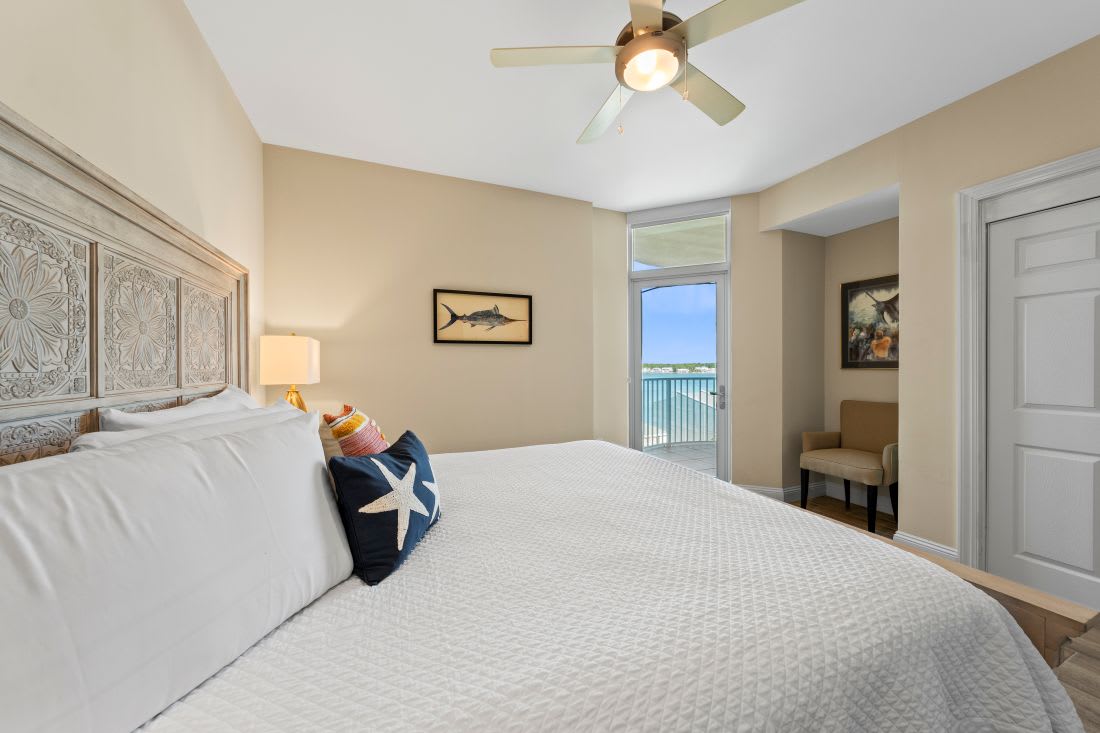 Wake up to stunning water views from your comfortable bed with coastal decor and gentle ceiling fan breezes.