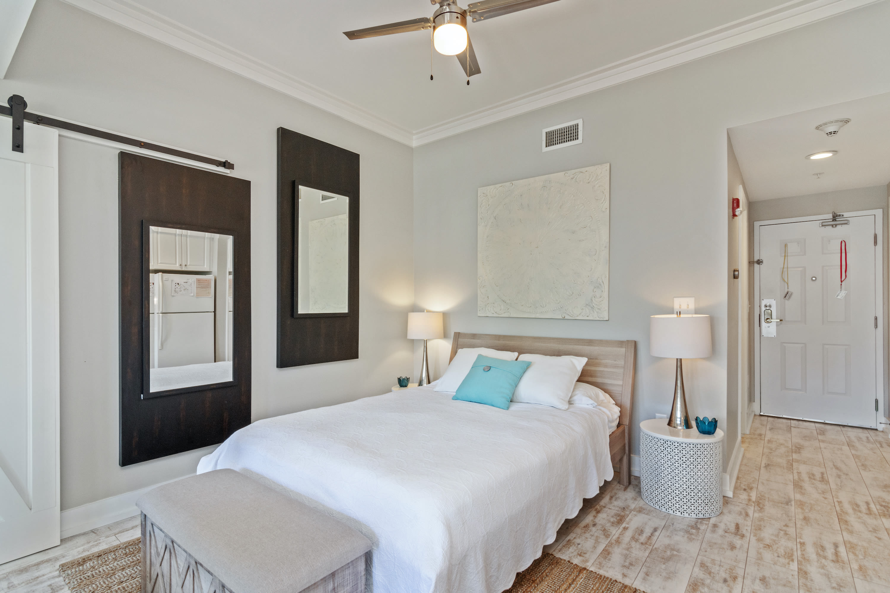 Serene sleeping space with a cozy queen bed, modern coastal accents, and calming neutral tones—perfect for unwinding after a day on 30A.