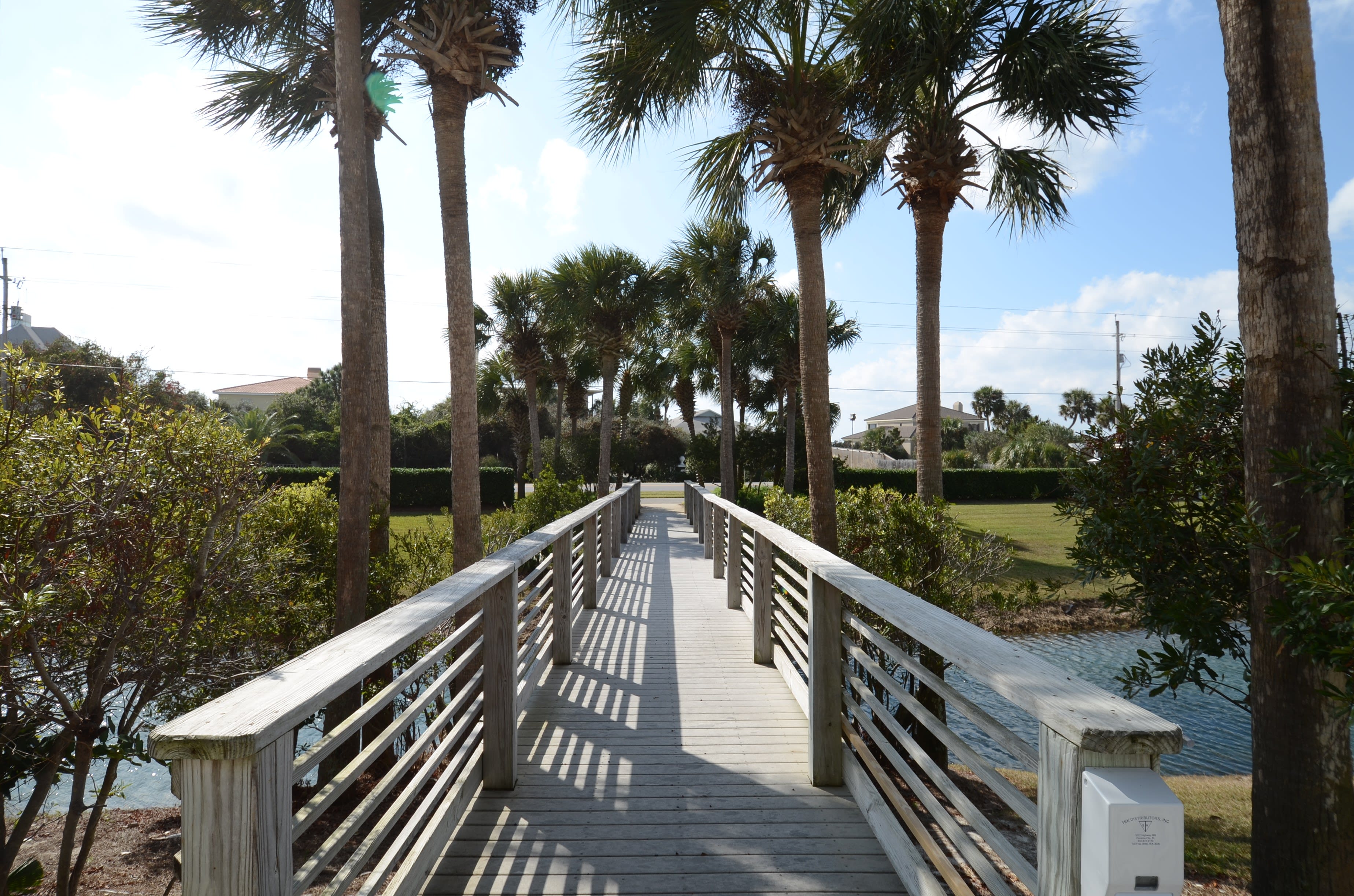Wooden walkway leading to a pond.