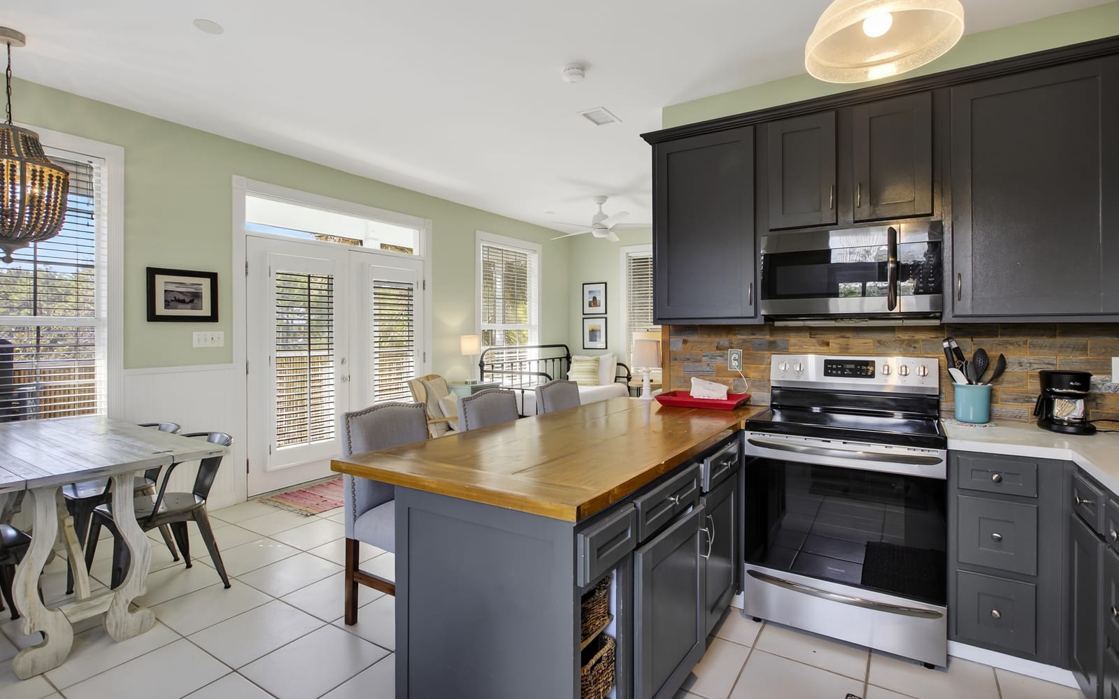 Cook memorable meals in your spacious kitchen with stainless appliances, wood countertops, and natural light streaming through French doors.