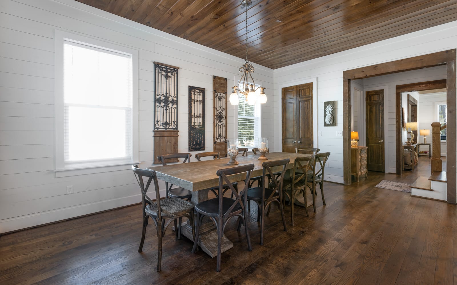 Gather around this stunning farmhouse dining table where warm wood meets elegant charm for memorable meals together.