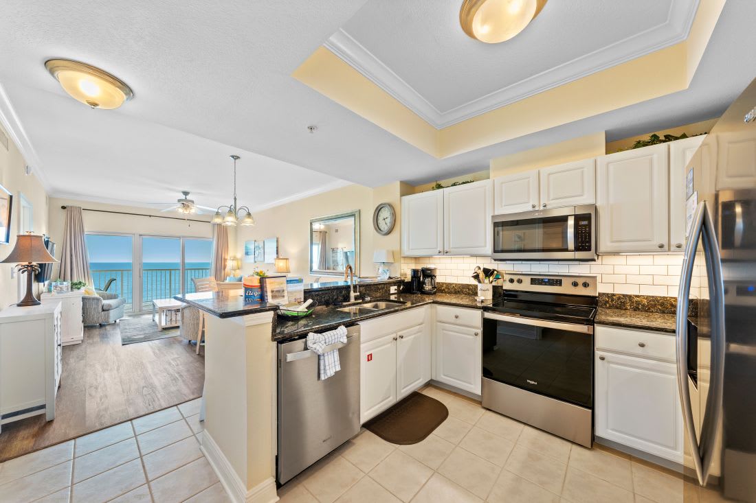 Your fully equipped kitchen features granite countertops and stainless appliances with stunning ocean views for inspiring meal prep.