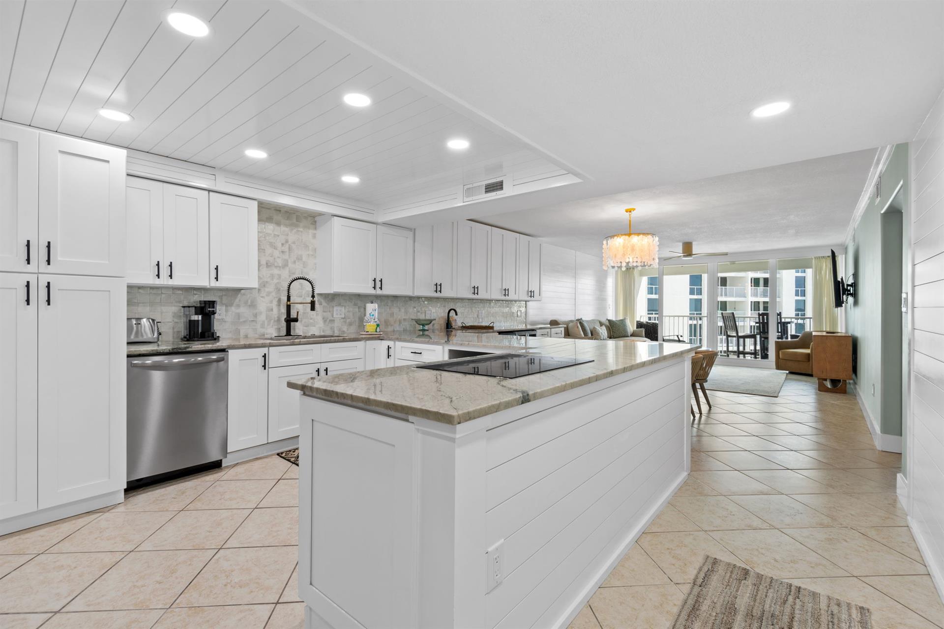 Cook your favorite meals in this stunning modern kitchen featuring granite countertops, stainless steel appliances, and abundant storage space.