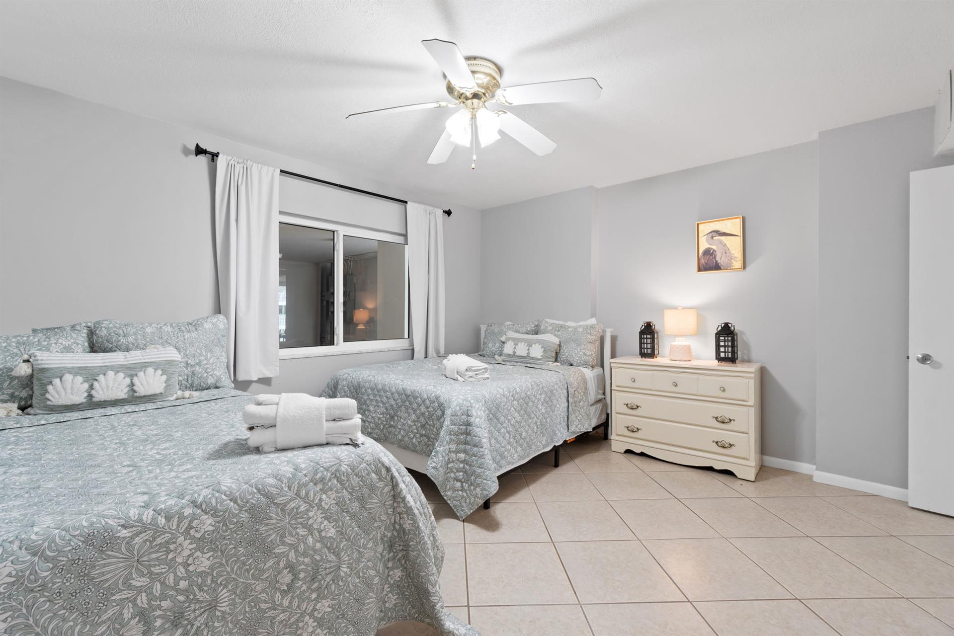 Your peaceful twin bedroom features comfortable beds with soft linens, gentle ceiling fan, and warm lighting for restful nights.