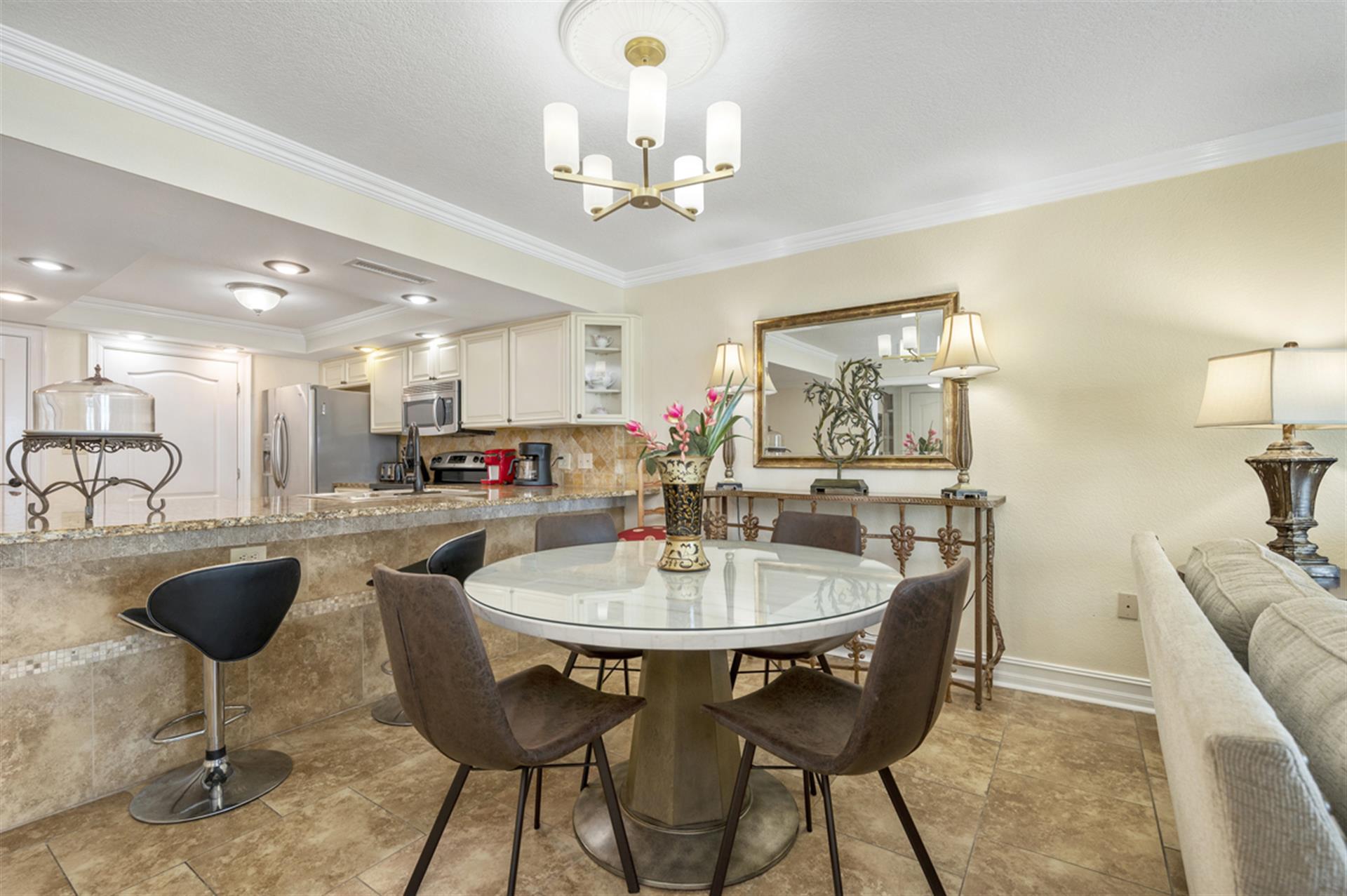 Gather around your elegant glass dining table for memorable meals in this beautifully appointed space with modern fixtures and sophisticated décor.