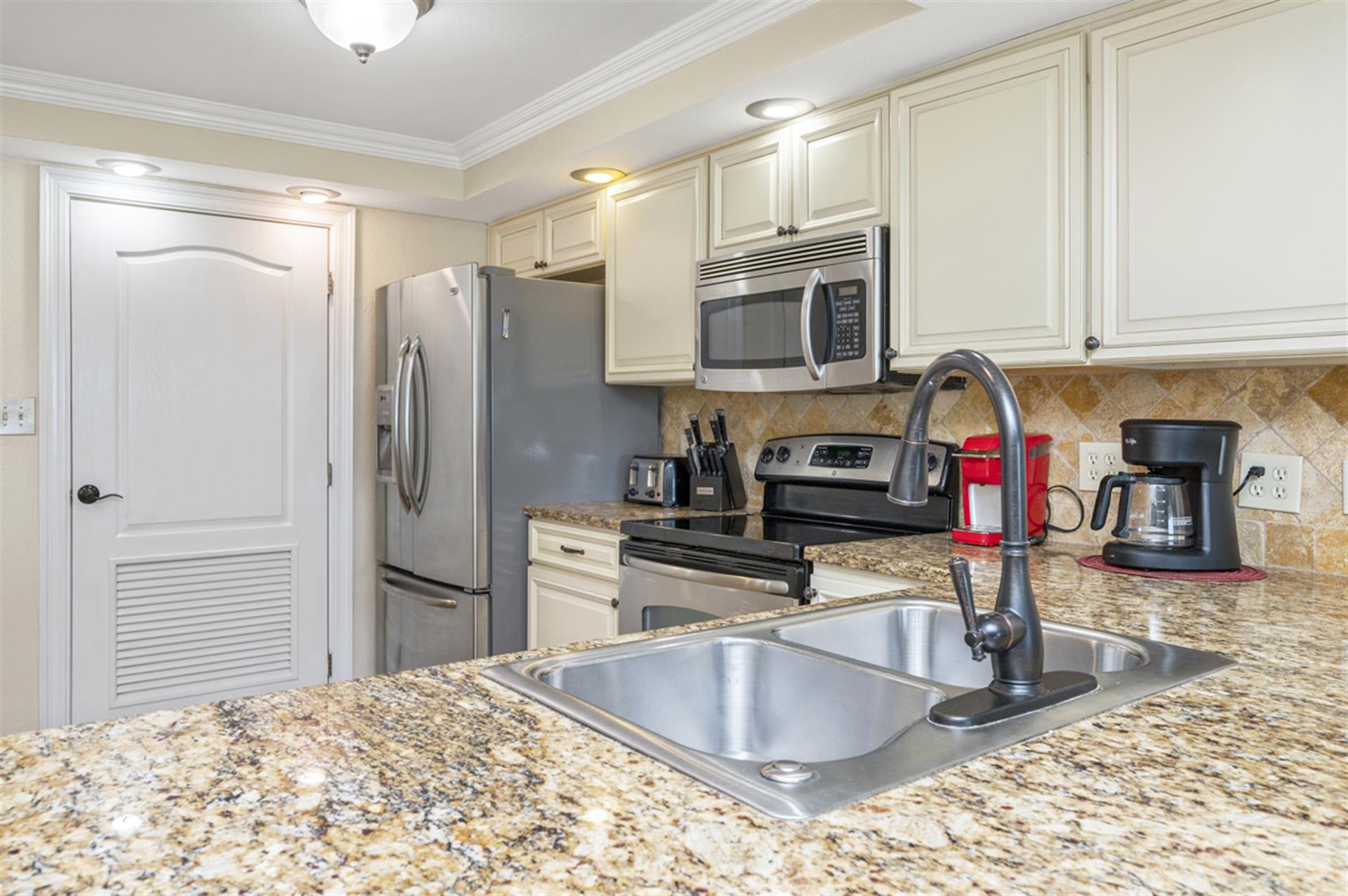 Your fully equipped kitchen features granite counters, stainless appliances, and everything you need to create memorable meals during your stay.