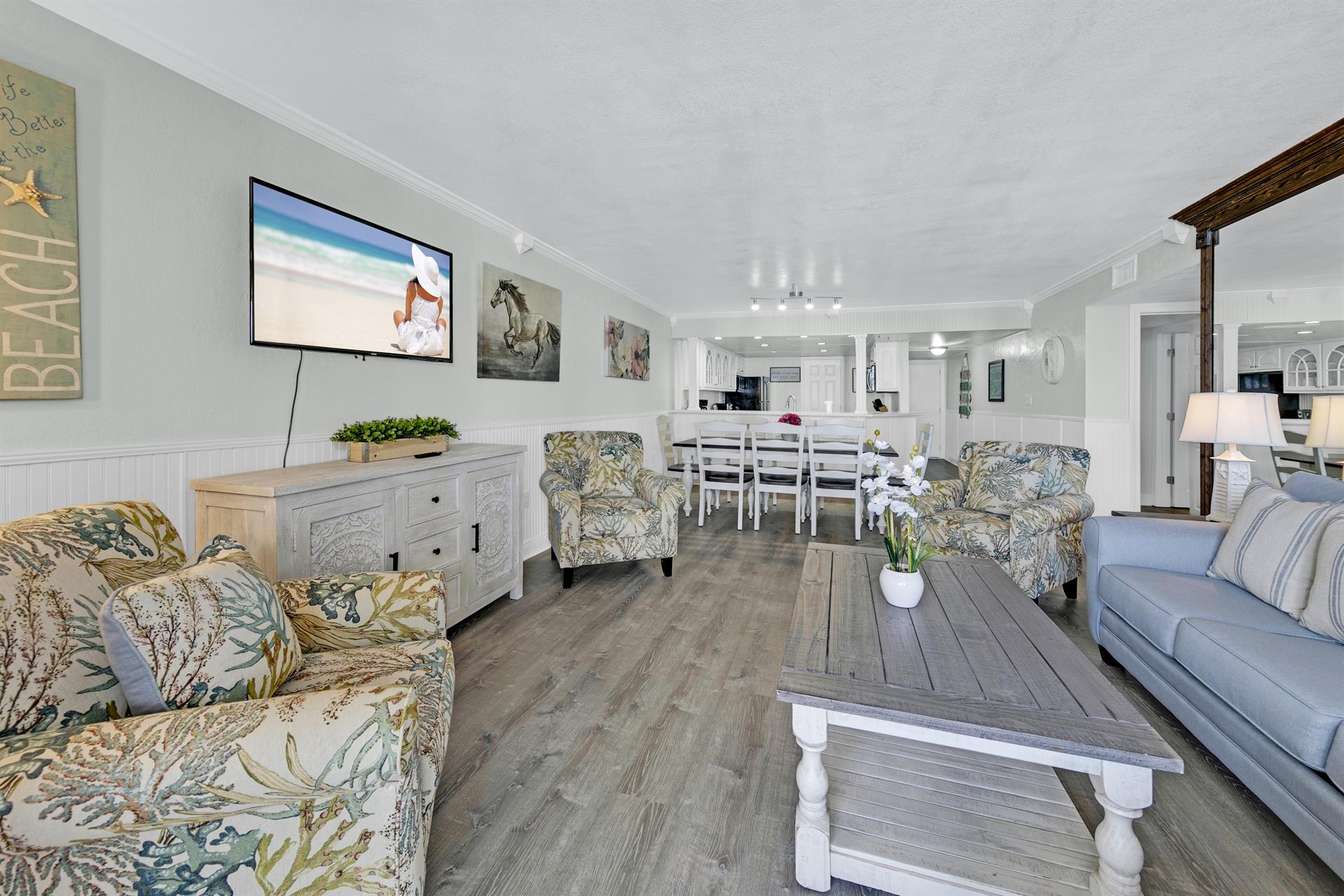Sink into coastal comfort in your spacious living room, where beach-themed décor and plush seating create the perfect retreat after sun-filled days.
