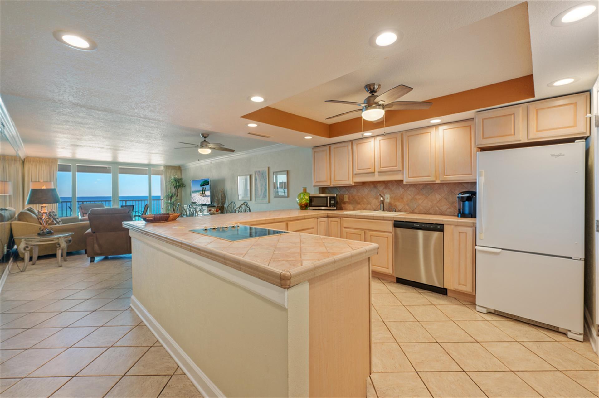 Prepare your favorite meals in this spacious kitchen featuring granite countertops and stunning ocean views beyond.