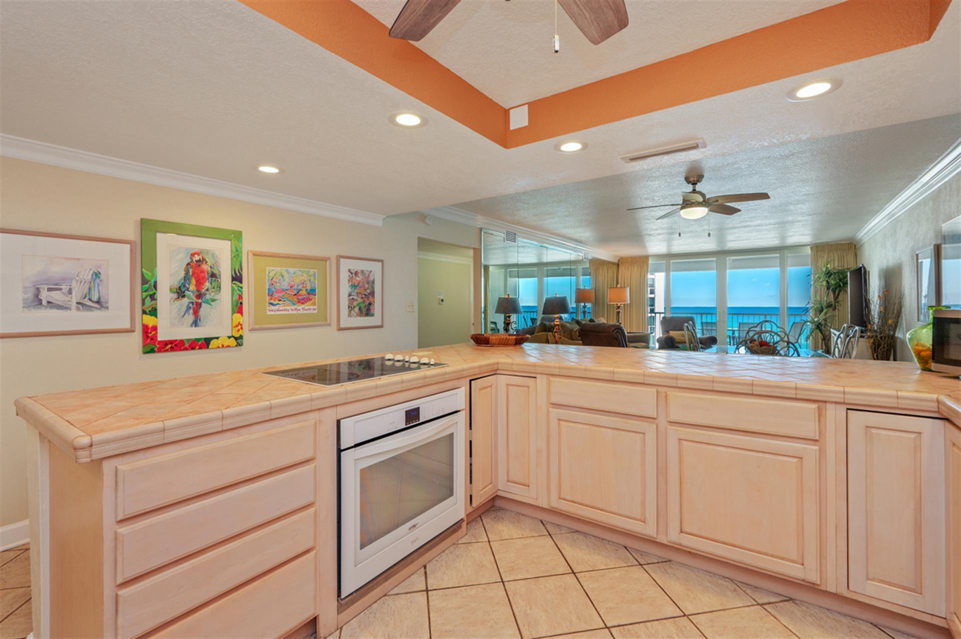 Your bright kitchen features granite counters, modern appliances, and stunning ocean views through the open floor plan.