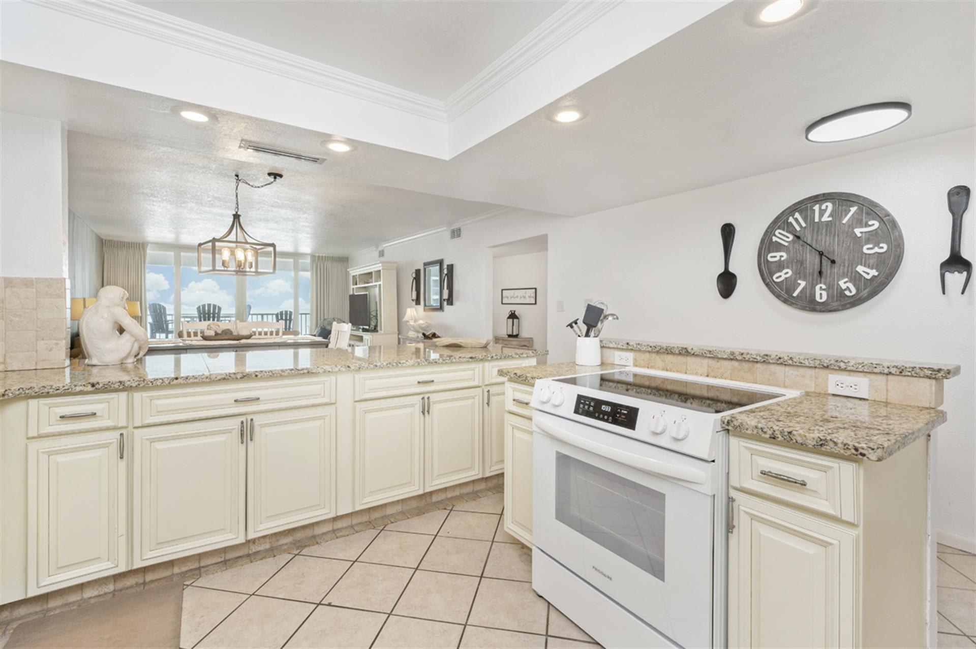 Your gourmet kitchen features granite counters, modern appliances, and stunning ocean views through floor-to-ceiling windows—perfect for memorable meals.