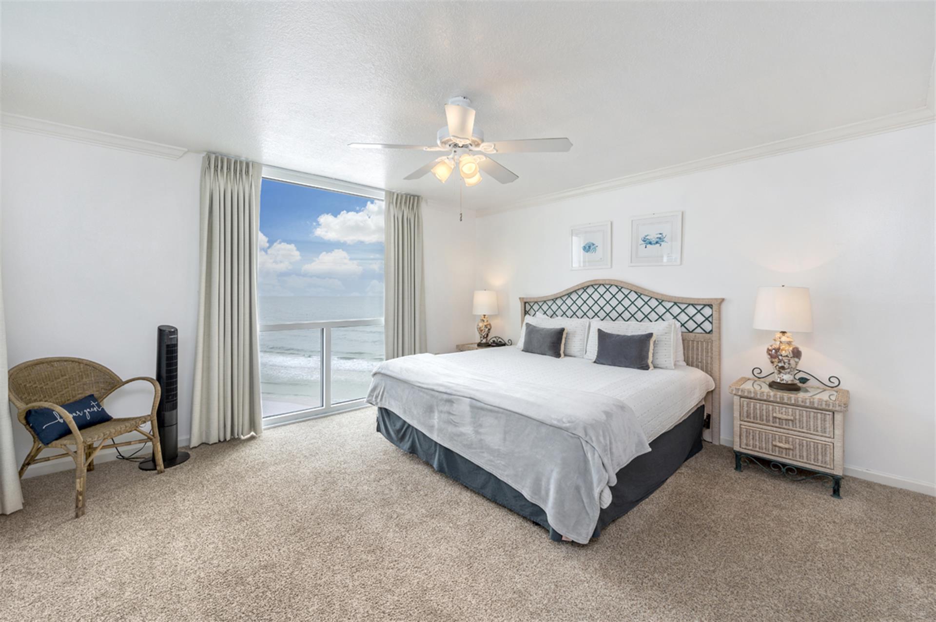 Wake up to breathtaking ocean views from your plush bed in this serene coastal retreat with elegant nautical touches.