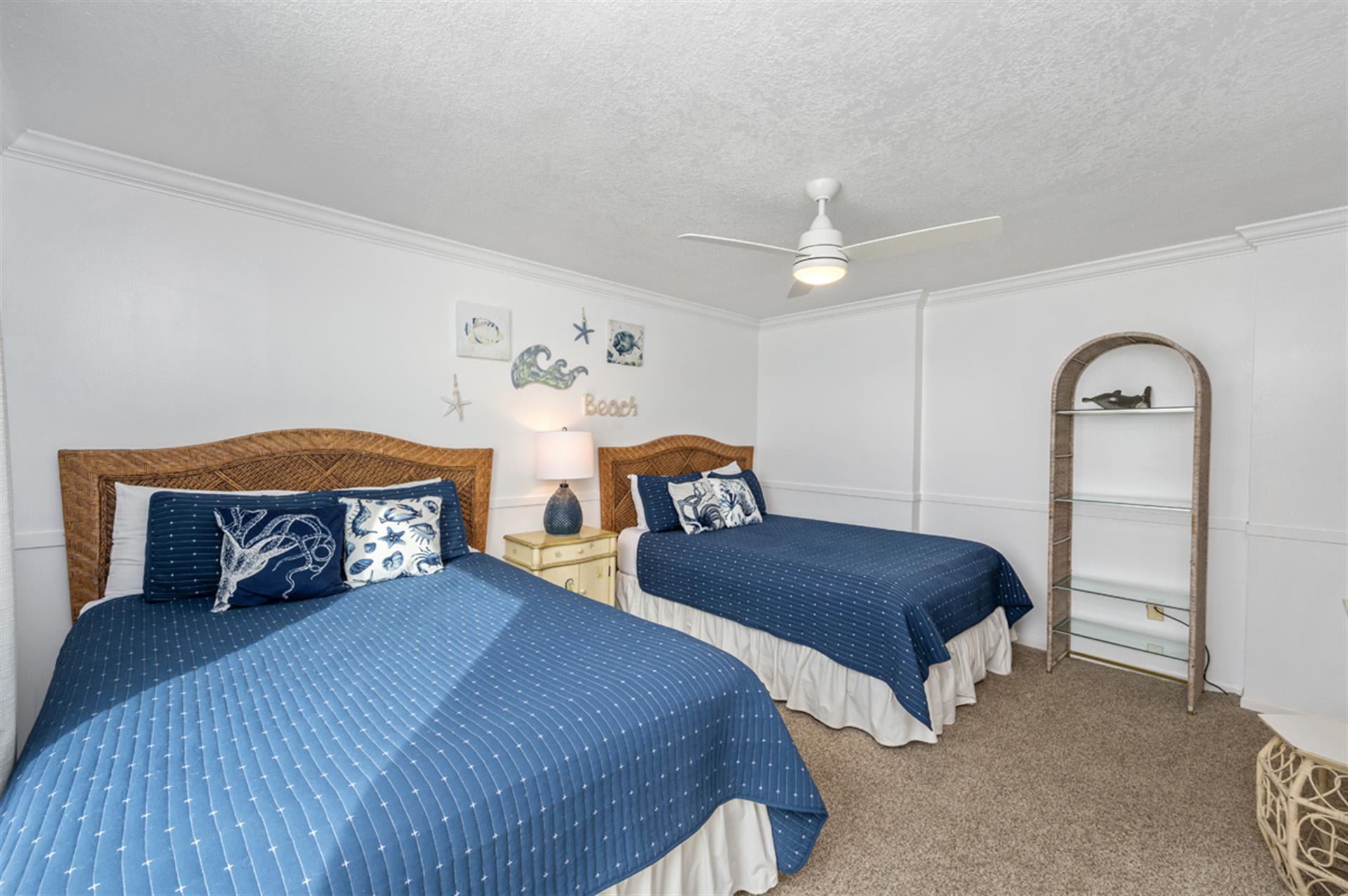 Drift off peacefully in your coastal-themed twin bedroom, where wicker headboards and ocean-blue quilts create the perfect seaside sanctuary for restful nights.