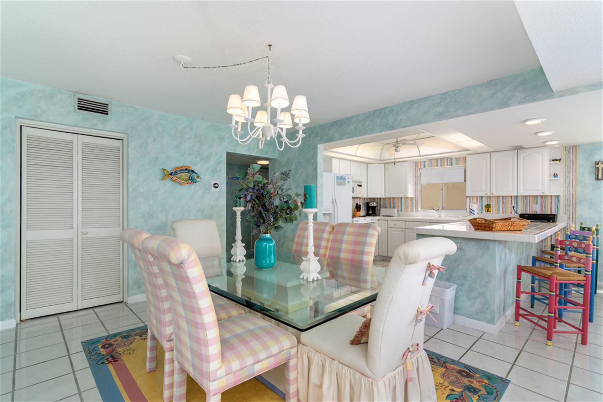 Your bright coastal dining area flows seamlessly into a fully-equipped kitchen, perfect for memorable meals together.
