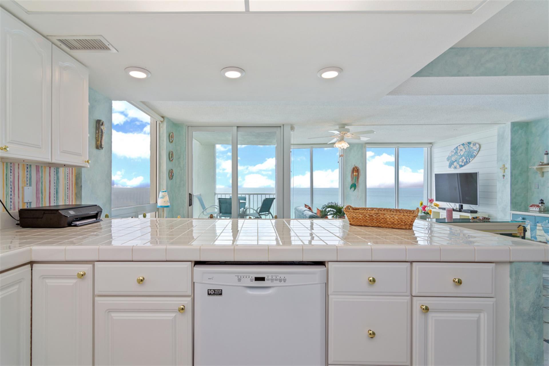 Prepare your favorite meals in this bright, beachfront kitchen while soaking in stunning ocean views through floor-to-ceiling windows.
