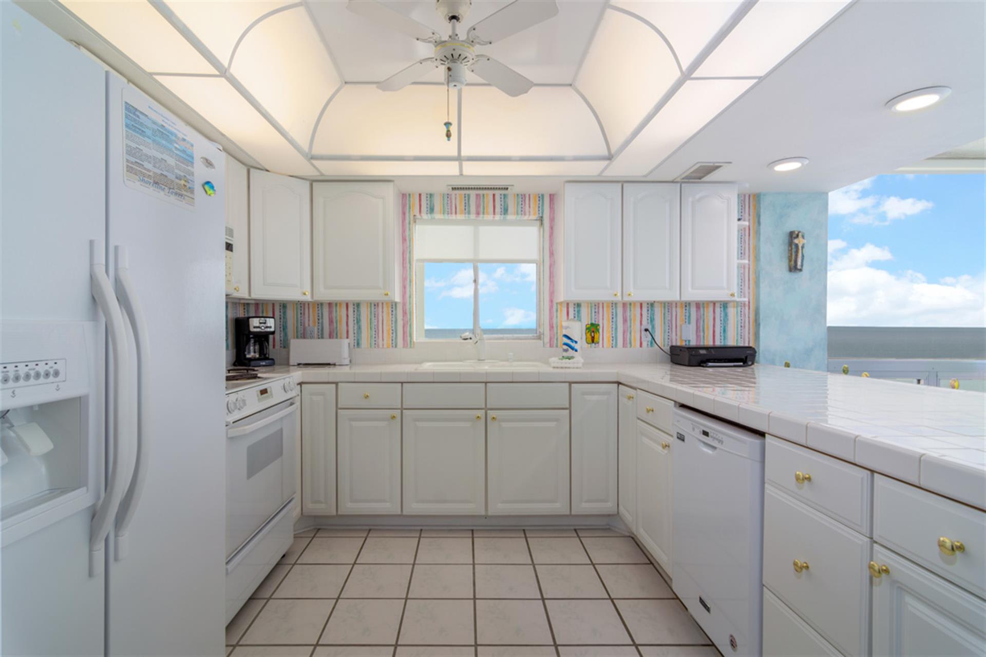 Step into your bright, fully-equipped kitchen where ocean views inspire culinary adventures and every meal becomes memorable.