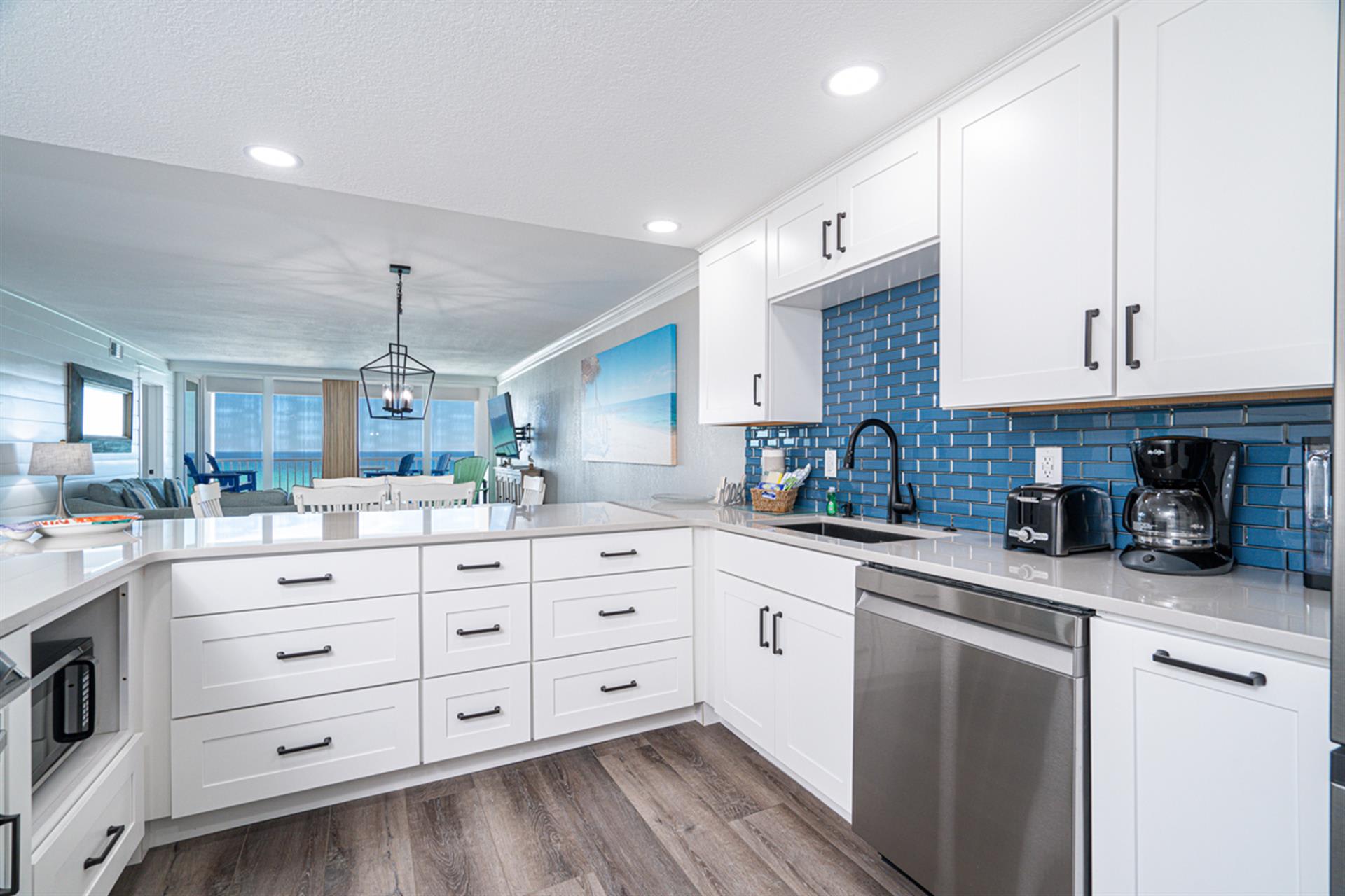 You'll love cooking in this bright, modern kitchen with stunning blue tile backsplash and ocean views beyond.