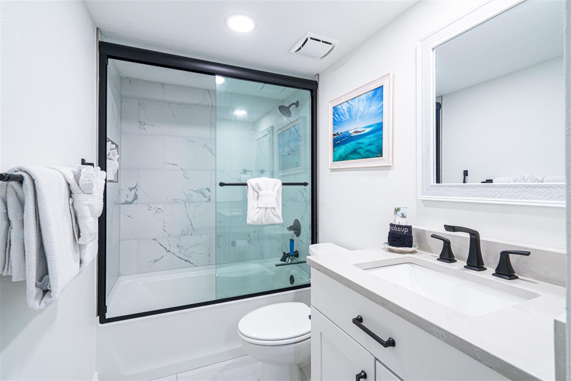 Step into your pristine bathroom featuring a luxurious marble-tiled shower and modern fixtures for your ultimate comfort.