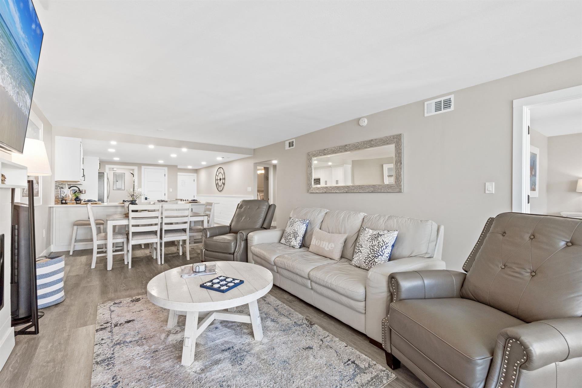 Relax in your stylish open-plan living space with plush leather seating and modern coastal touches throughout.