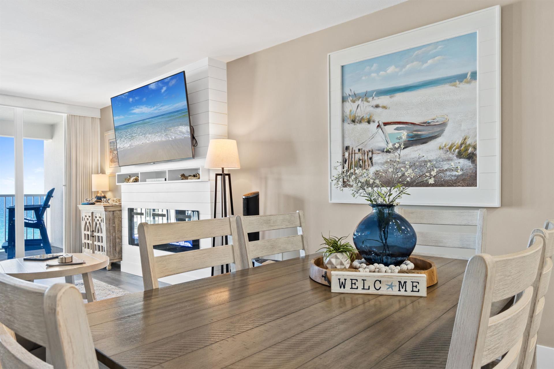 Gather around your spacious dining table where ocean views and coastal artwork create the perfect backdrop for memorable meals together.