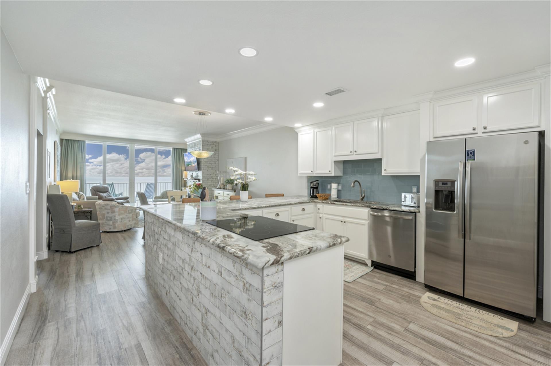 Your spacious kitchen flows into the living area, perfect for cooking while chatting with loved ones on your oceanfront getaway.