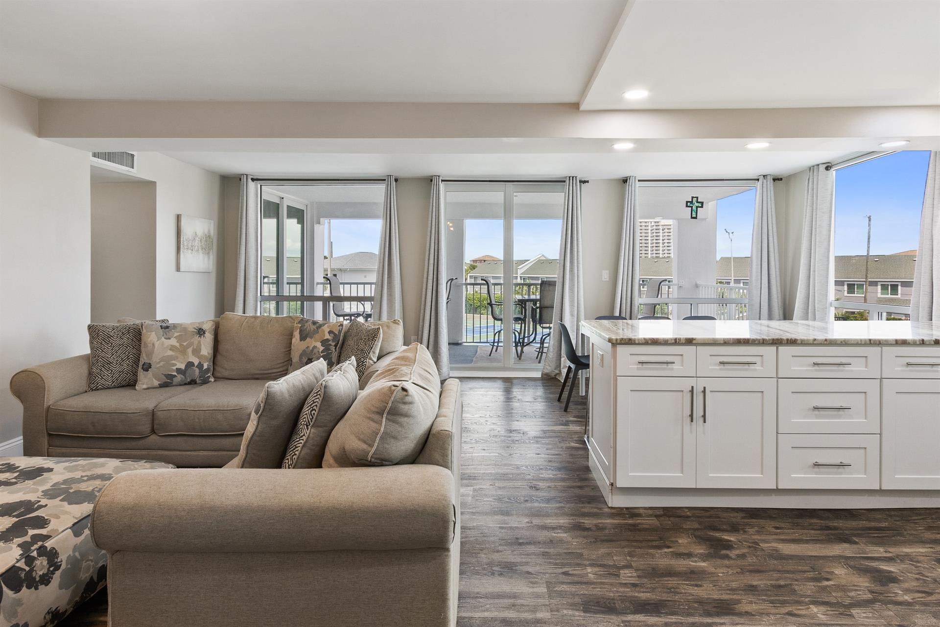 Unwind in your bright open-plan living space with plush seating and a modern kitchen that flows seamlessly to your private balcony.