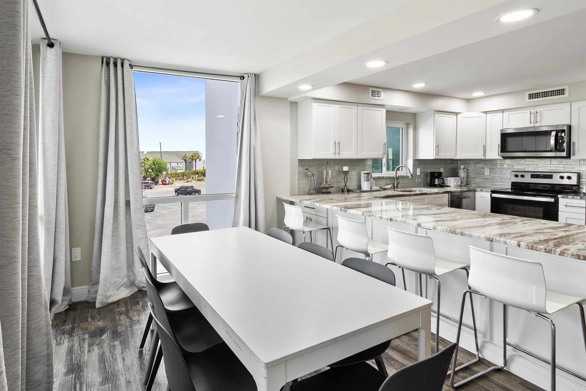 Your modern kitchen flows seamlessly with the dining area, featuring gleaming granite counters and contemporary finishes perfect for memorable meals.