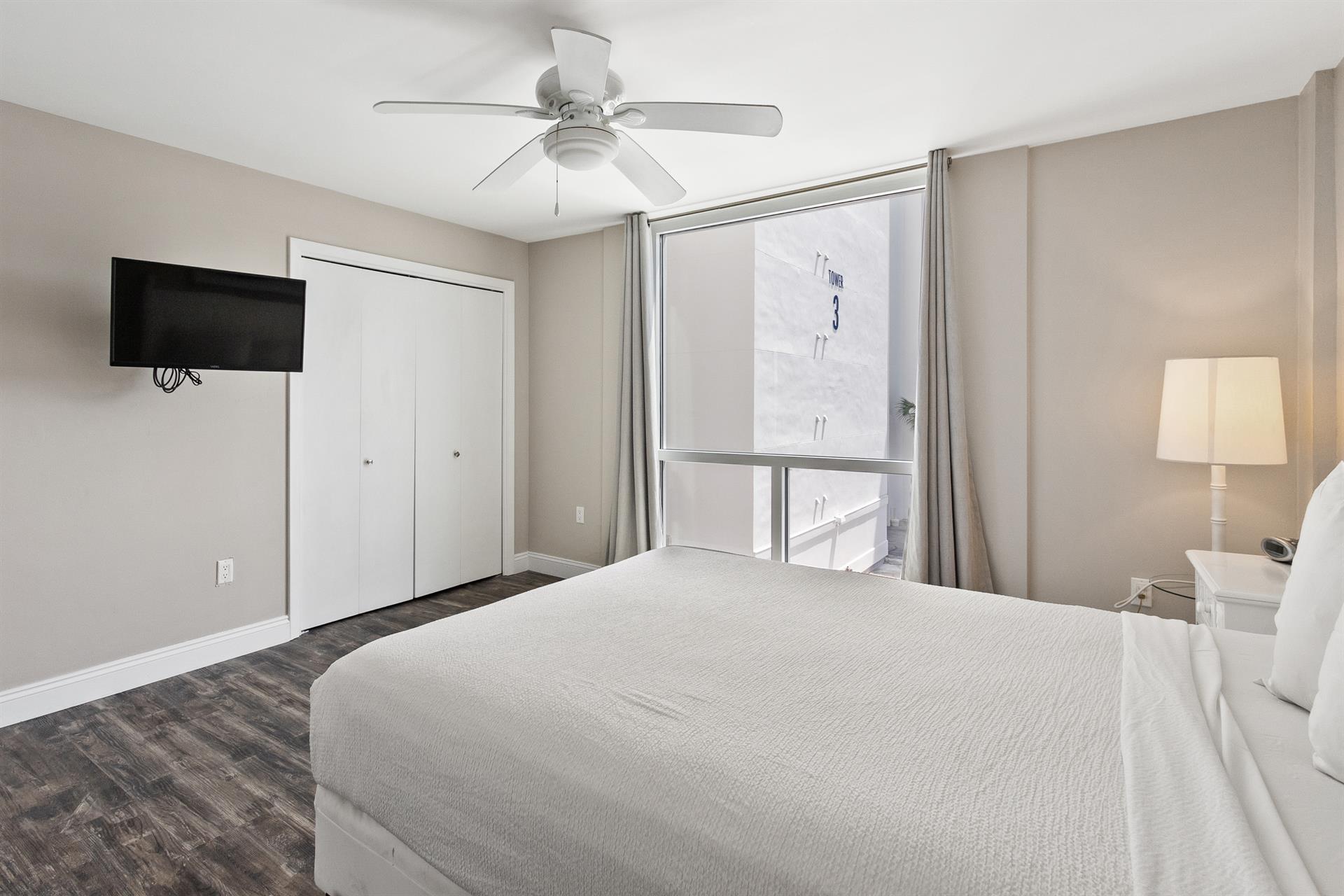Rest peacefully in your bright, modern bedroom with cooling ceiling fan, flat-screen TV, and city views from your window.