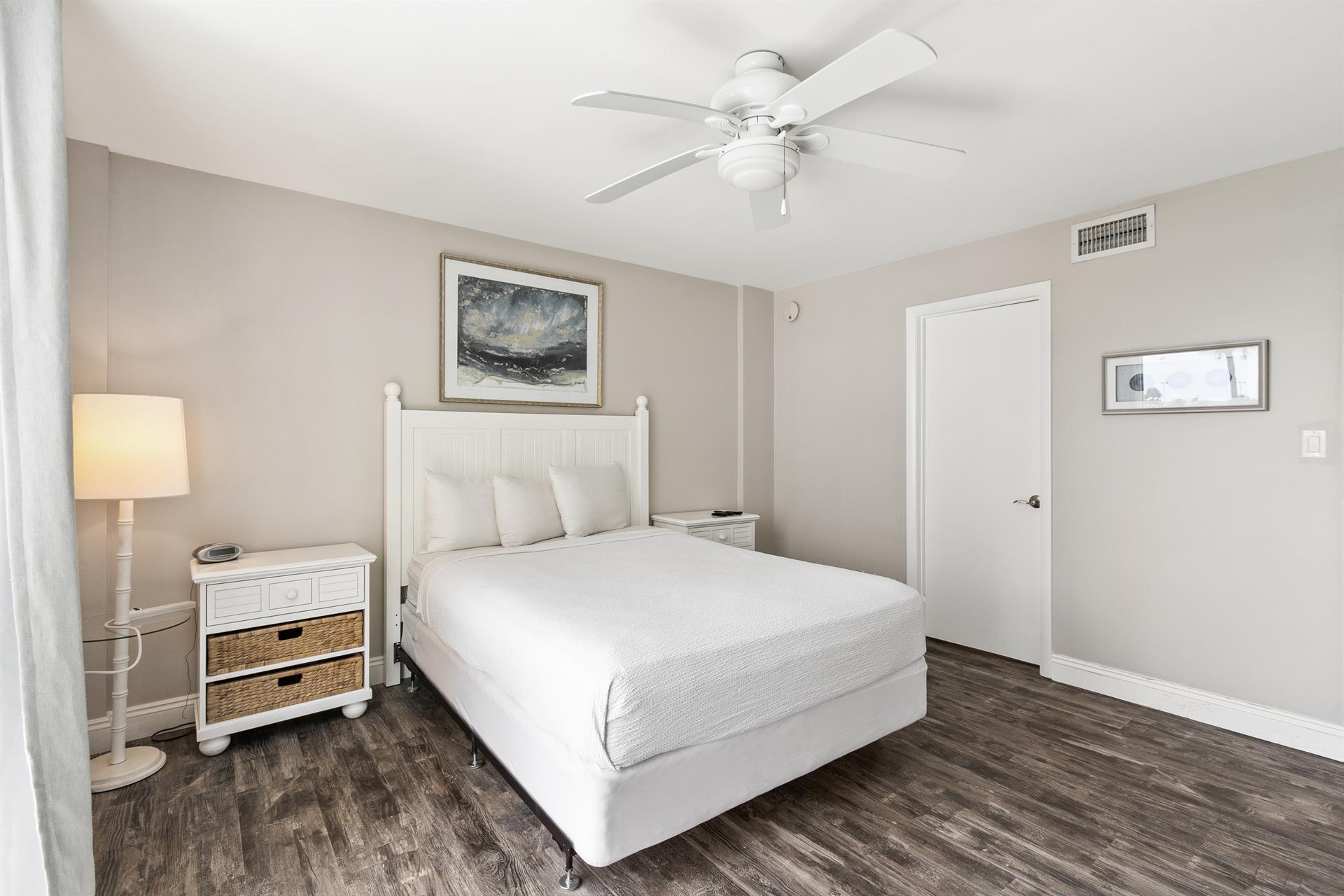 Drift into peaceful sleep in your serene bedroom featuring crisp white linens and coastal charm.