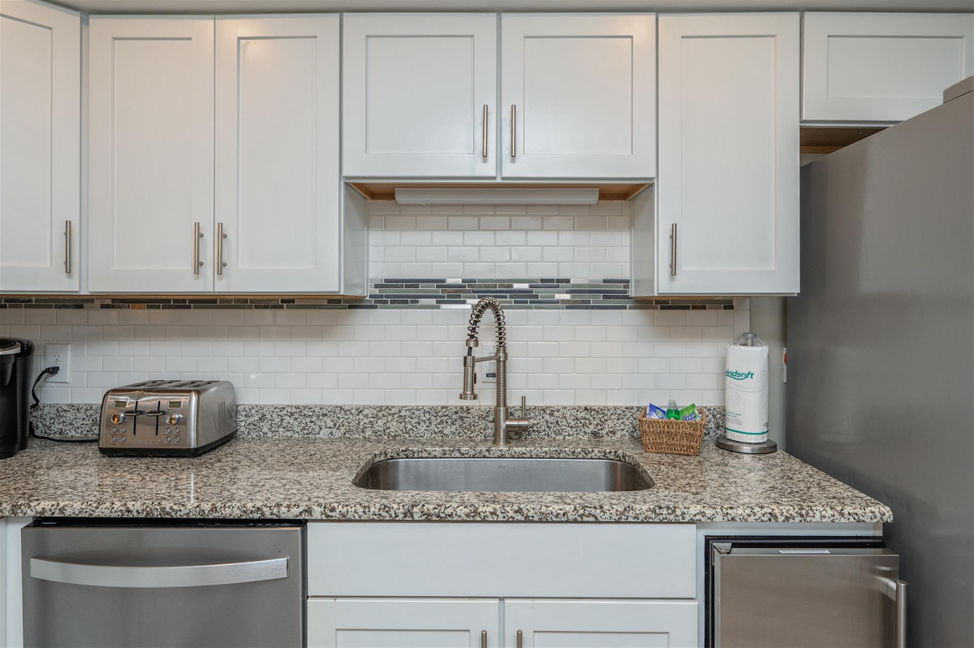 Your fully equipped kitchen features granite countertops, modern appliances, and everything you need to prepare meals at home.