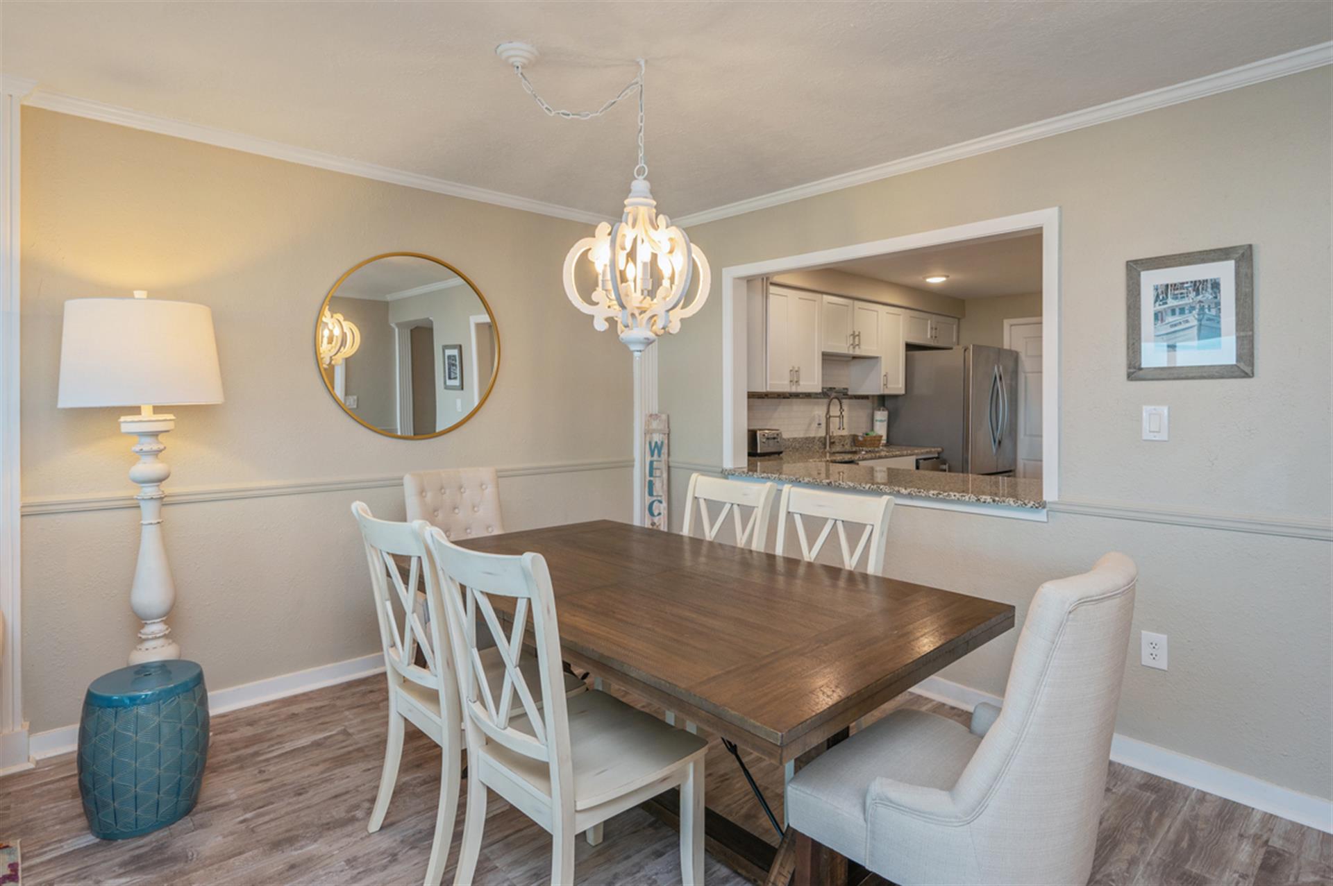 Gather around your elegant dining table for memorable meals, with warm pendant lighting and an open view to your fully-equipped kitchen.