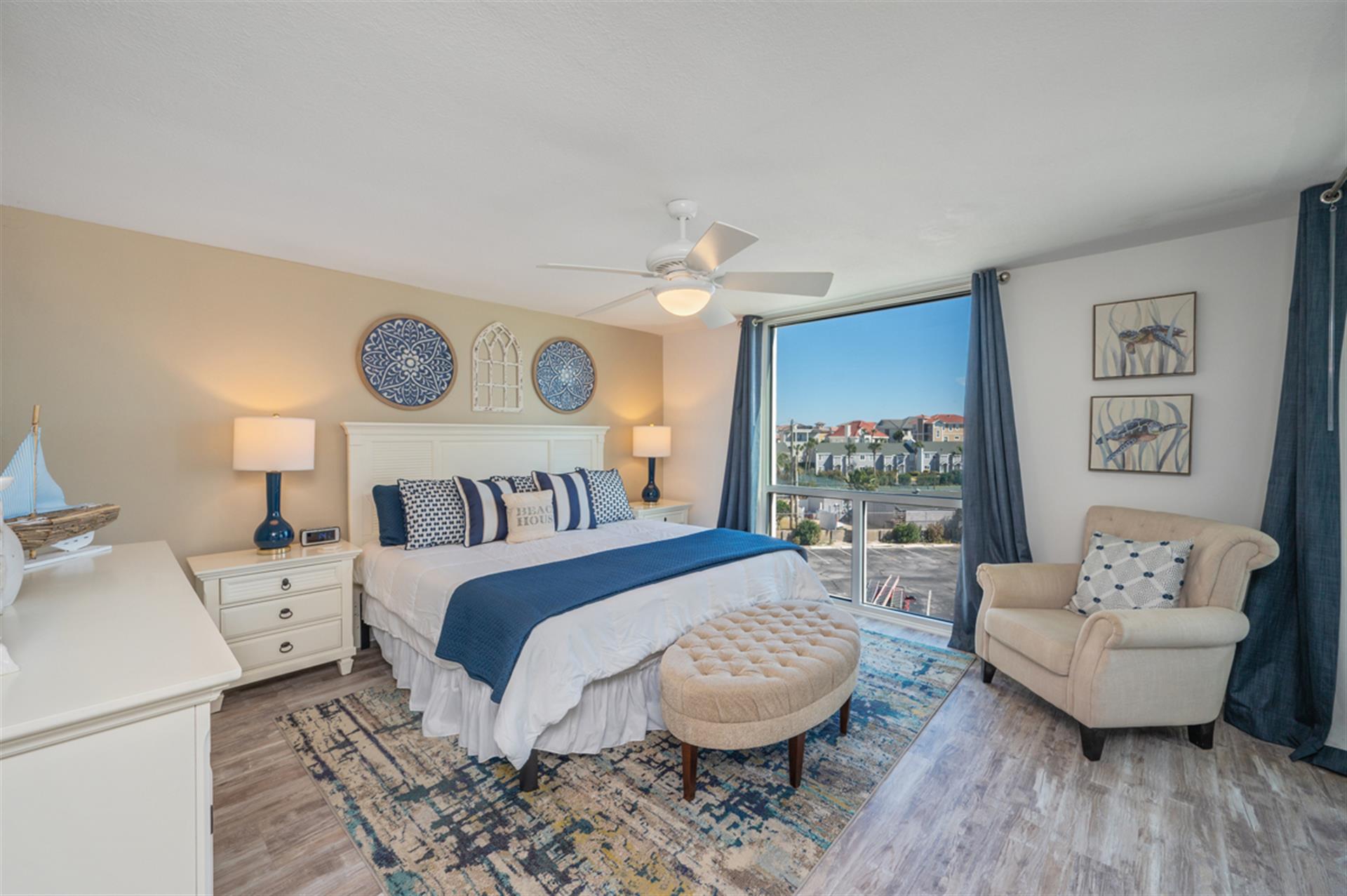 Wake to stunning city views in your serene bedroom sanctuary with coastal-inspired blues and nautical touches creating perfect relaxation.
