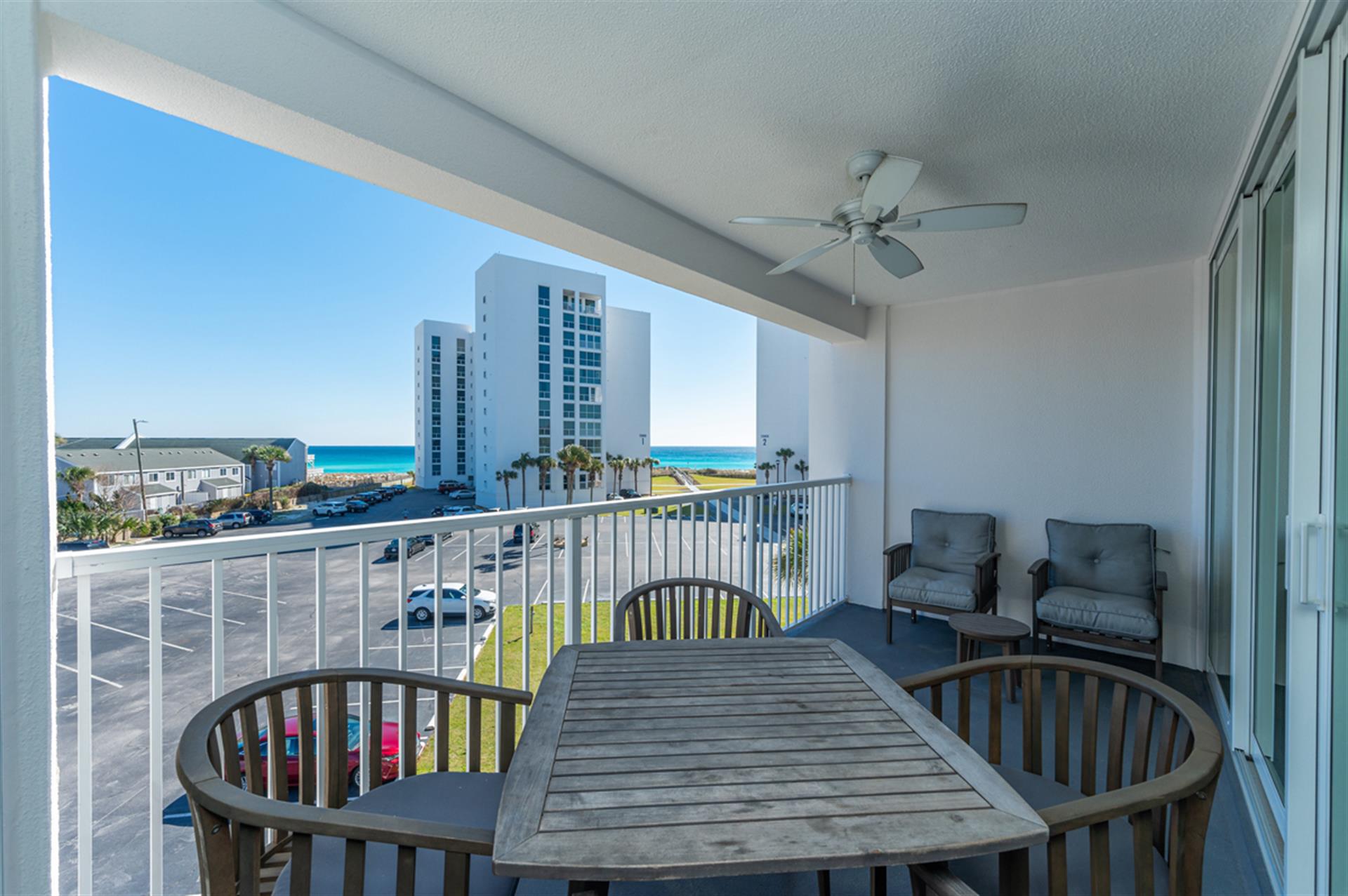 Enjoy your morning coffee at this oceanview dining table, with comfortable seating and glimpses of turquoise waters beyond the balcony.