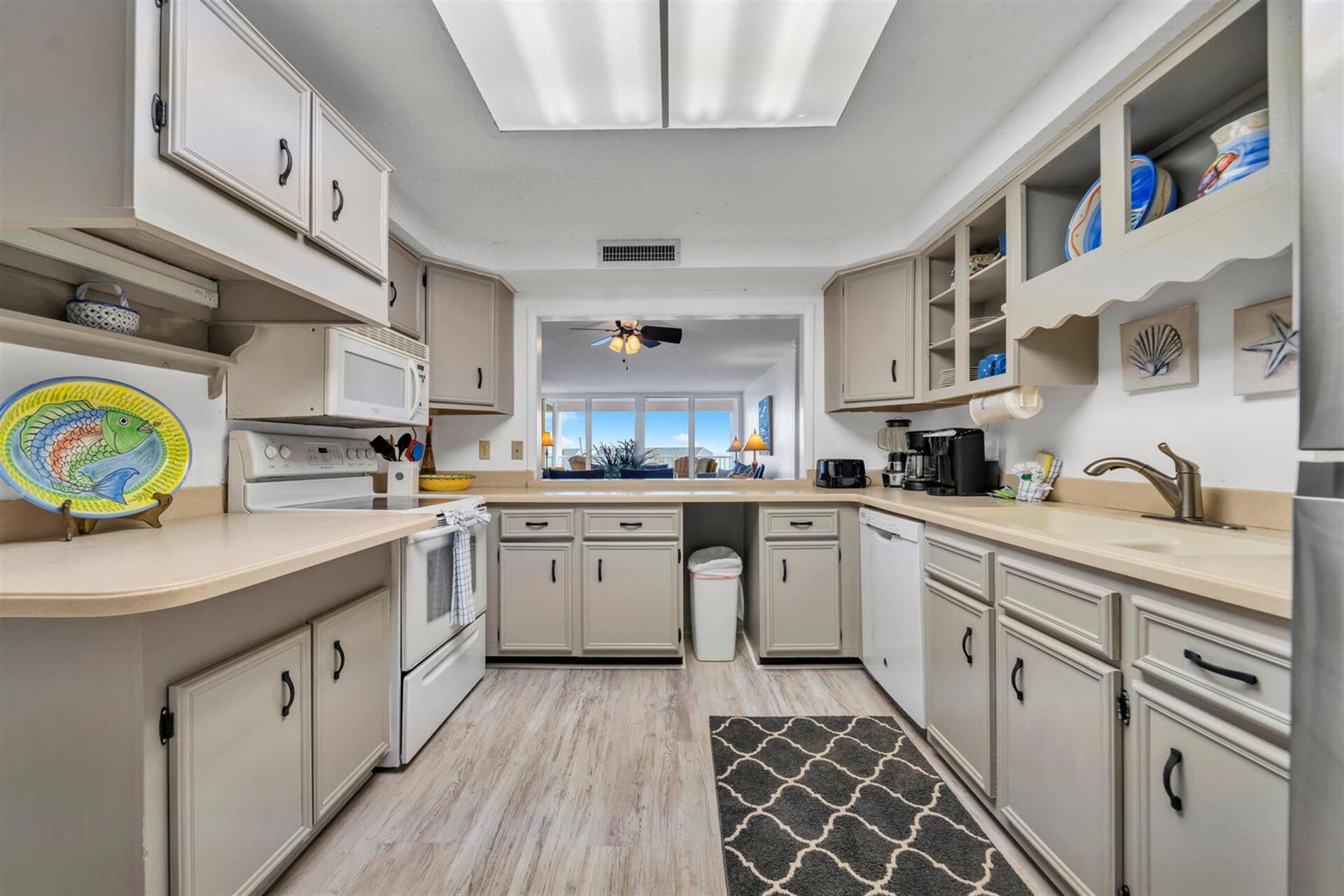 Your fully equipped kitchen features modern appliances and ample counter space, perfect for preparing meals while enjoying the coastal view.