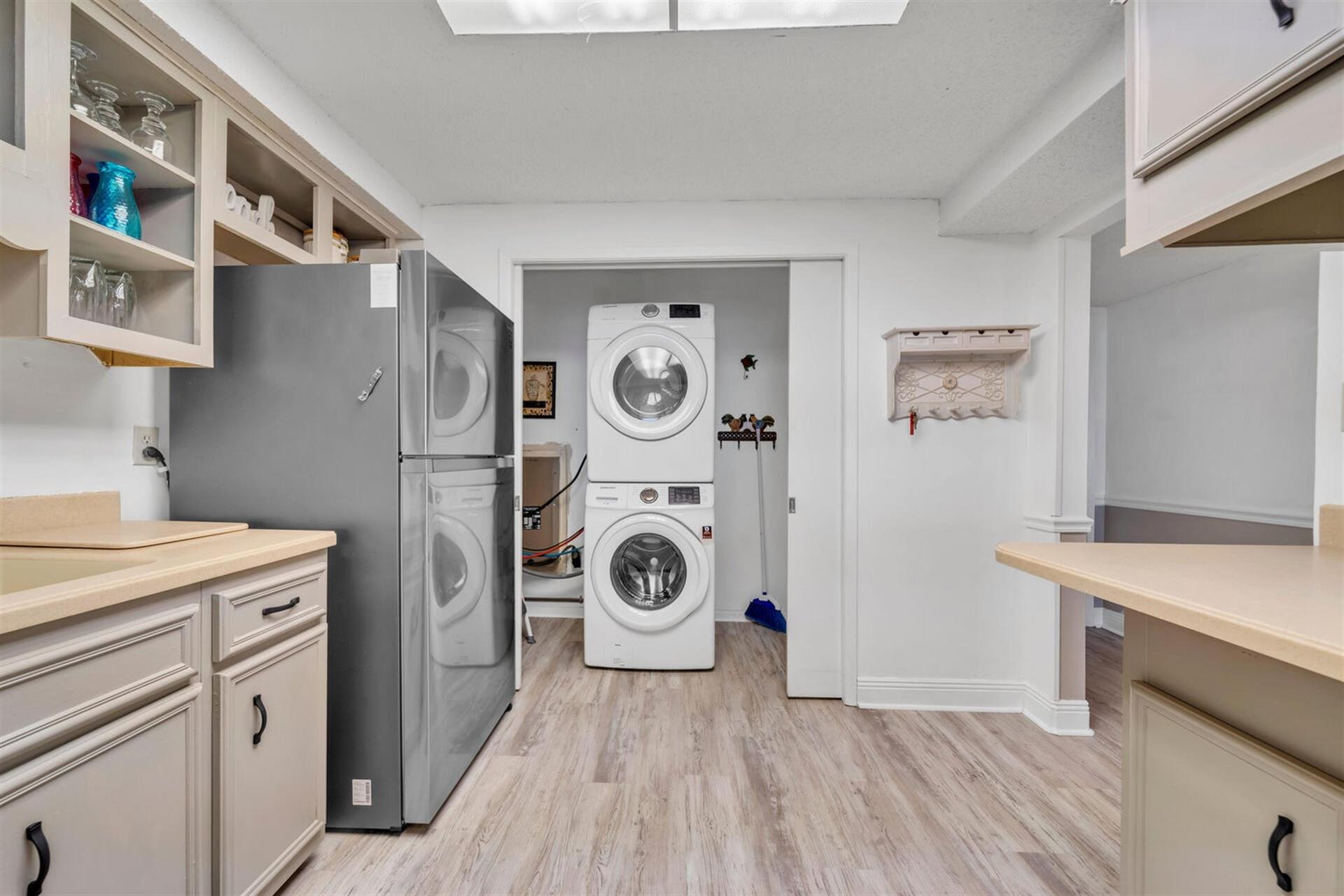 Your beautiful kitchen flows into a dedicated laundry room with modern appliances, making meal prep and cleanup effortlessly convenient.