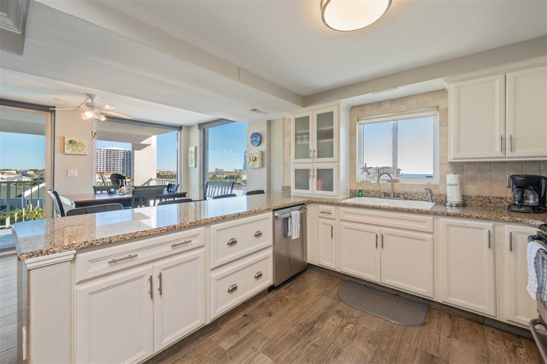Your fully equipped kitchen opens to stunning ocean views, perfect for cooking while enjoying the coastal scenery through panoramic windows.