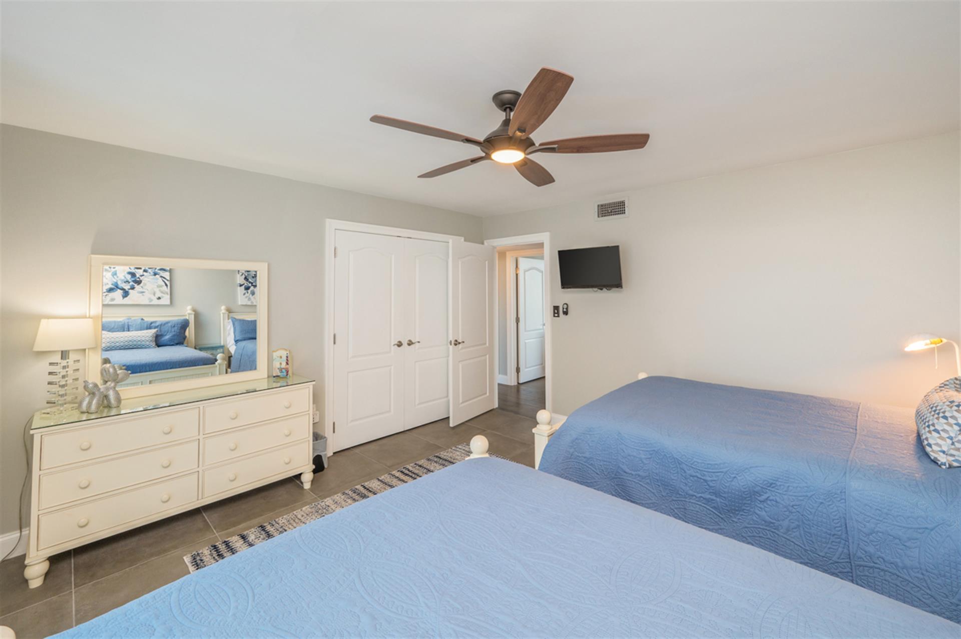 Drift off in this serene twin bedroom where coastal blues meet crisp whites, creating your perfect peaceful retreat.
