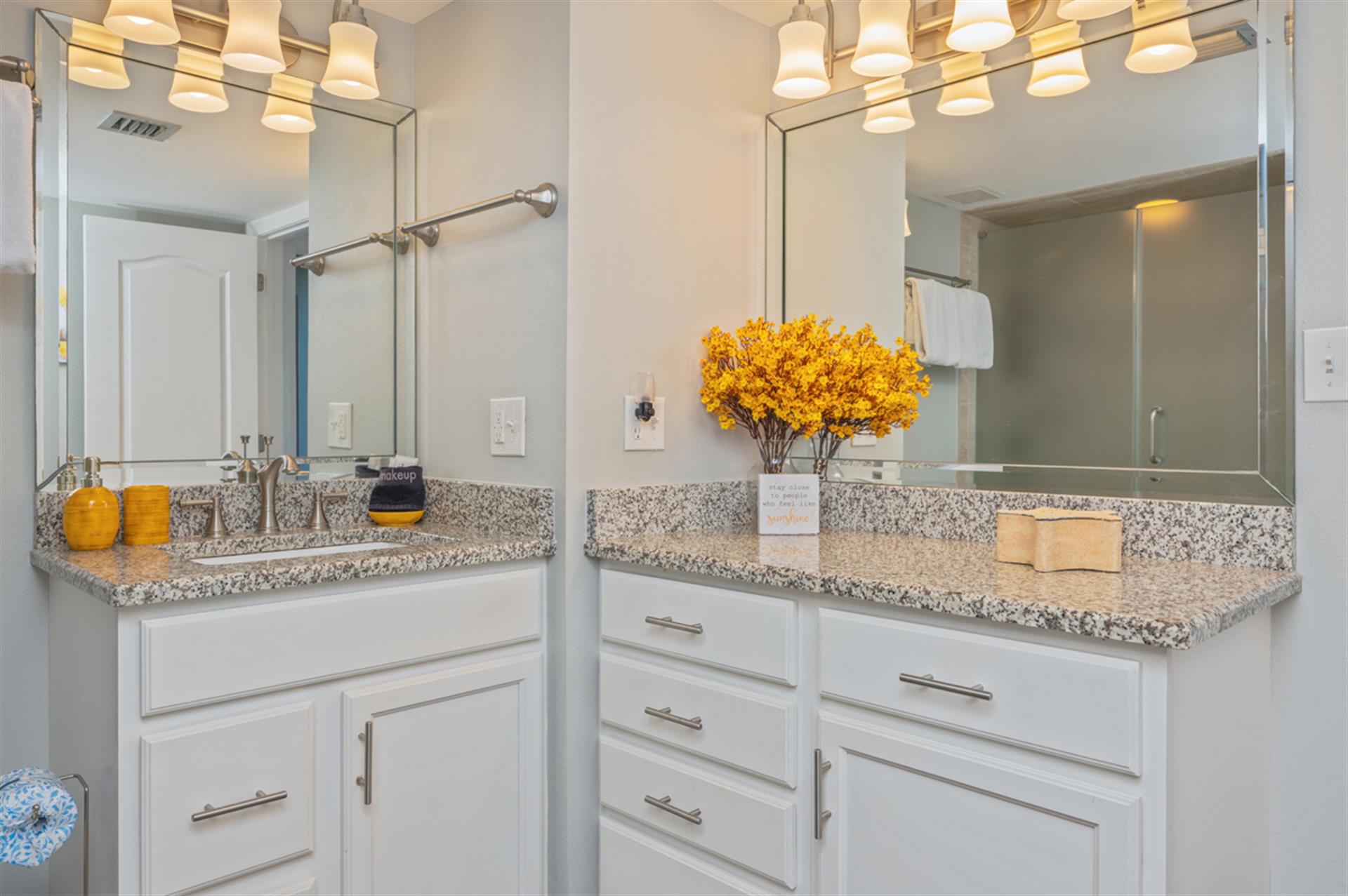 Your bright bathroom features dual vanities, granite counters, and warm lighting to start your mornings perfectly.