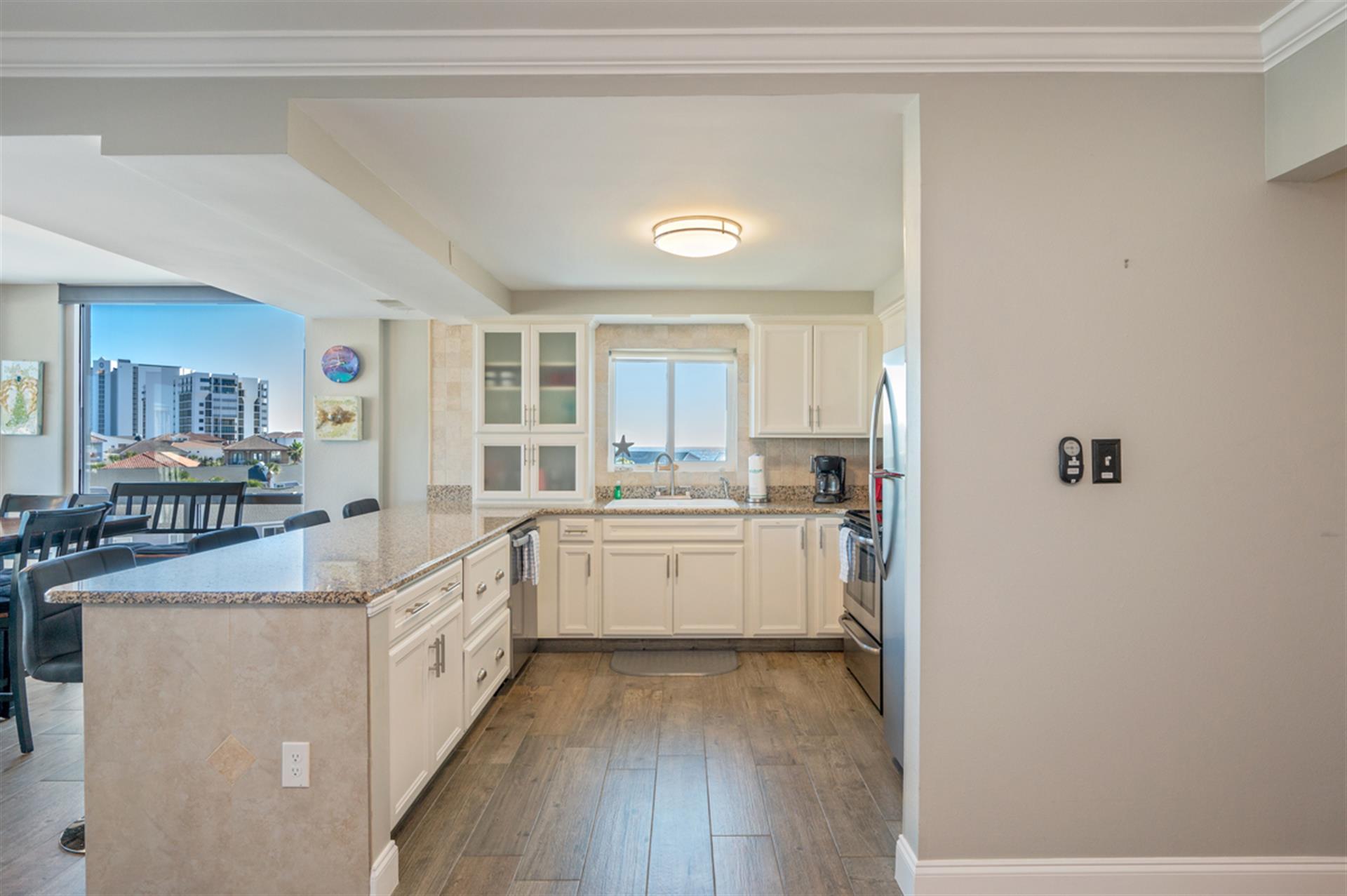 Your fully-equipped kitchen features granite counters, stainless appliances, and stunning city views while you cook memorable meals.