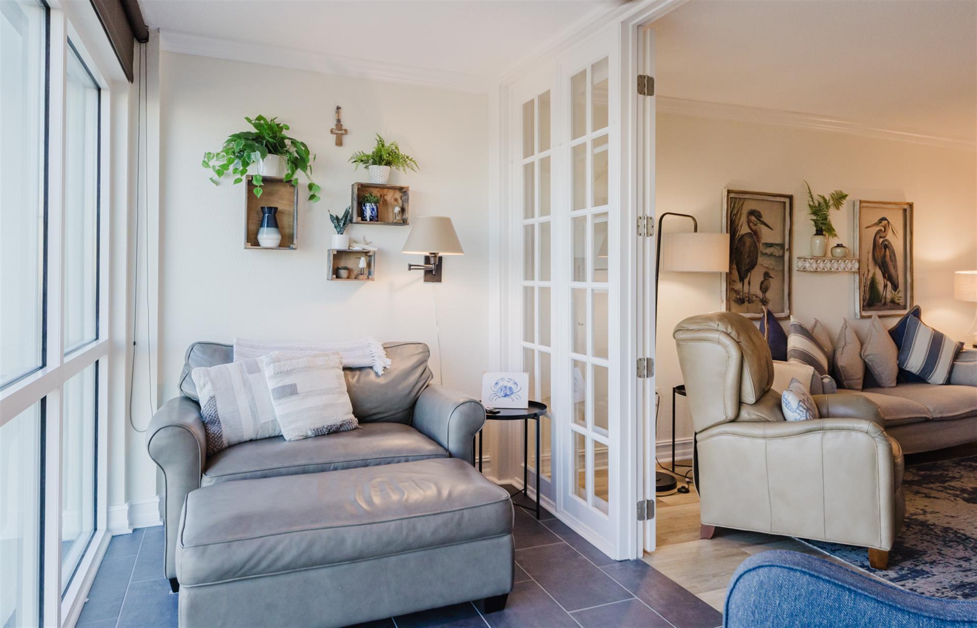 Sink into your private reading nook by the window, where soft light and thoughtful decor create the perfect spot to unwind.