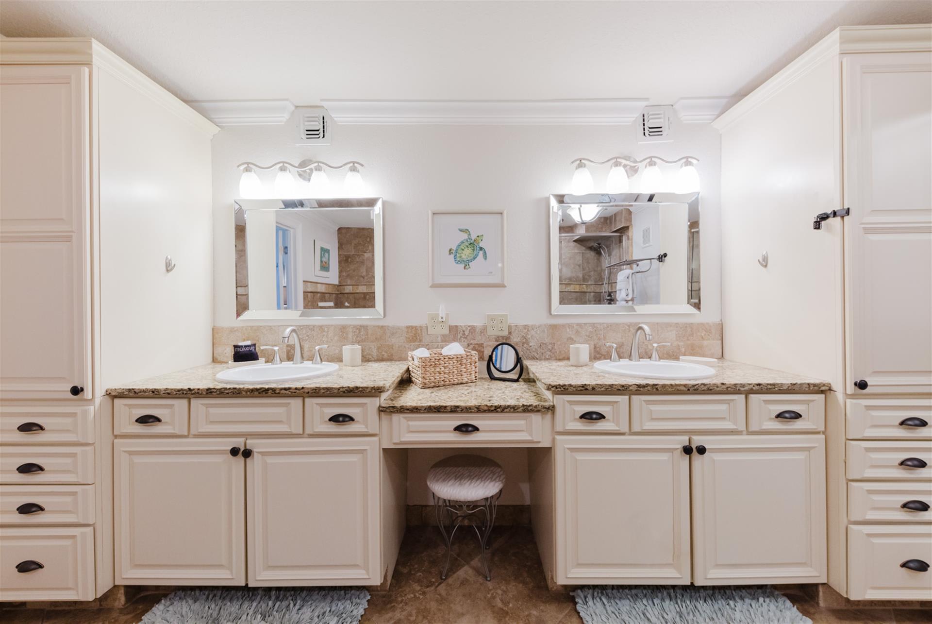 Indulge in this luxurious master bathroom with dual vanities, granite countertops, and abundant storage for your morning routine.