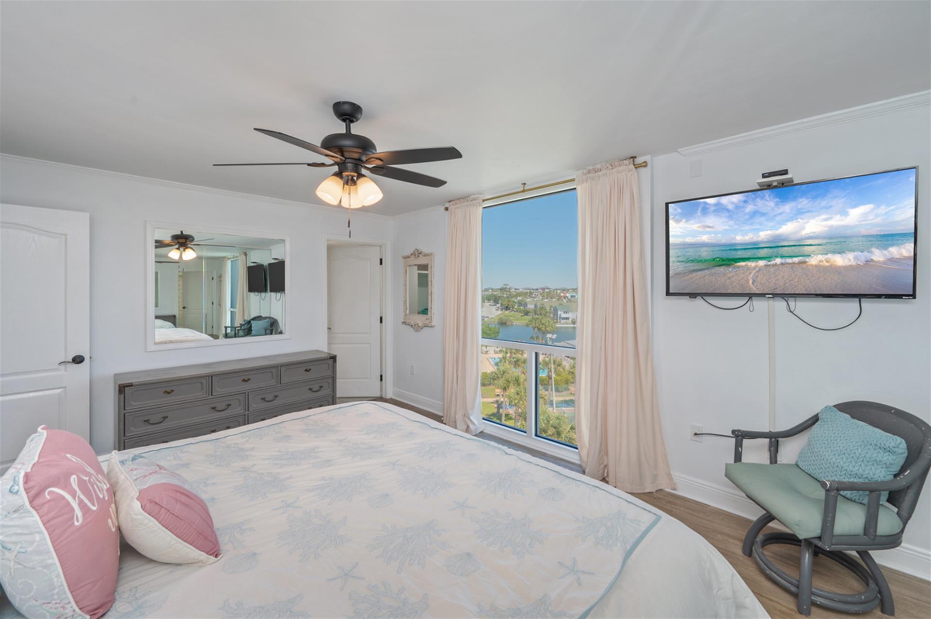 Drift off to sleep in your serene bedroom with stunning lake views, gentle ceiling fan, and cozy seating where you can unwind.
