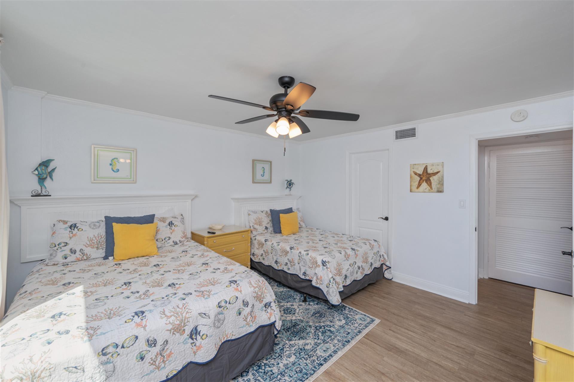 Drift off to sleep in this charming twin bedroom featuring ocean-themed bedding and coastal artwork that brings the seaside indoors.
