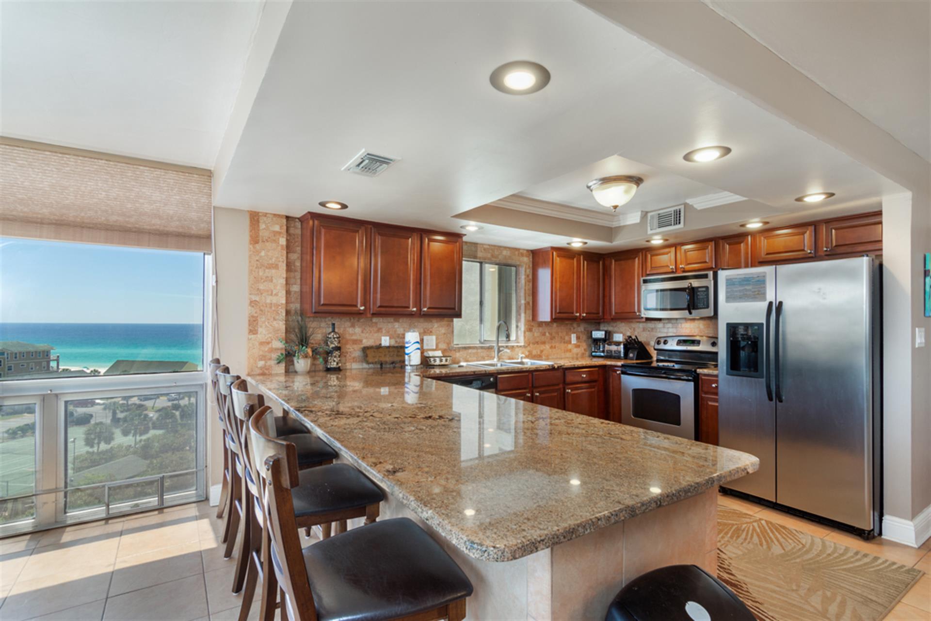 Prepare meals in your gourmet kitchen while soaking up stunning ocean views through floor-to-ceiling windows.